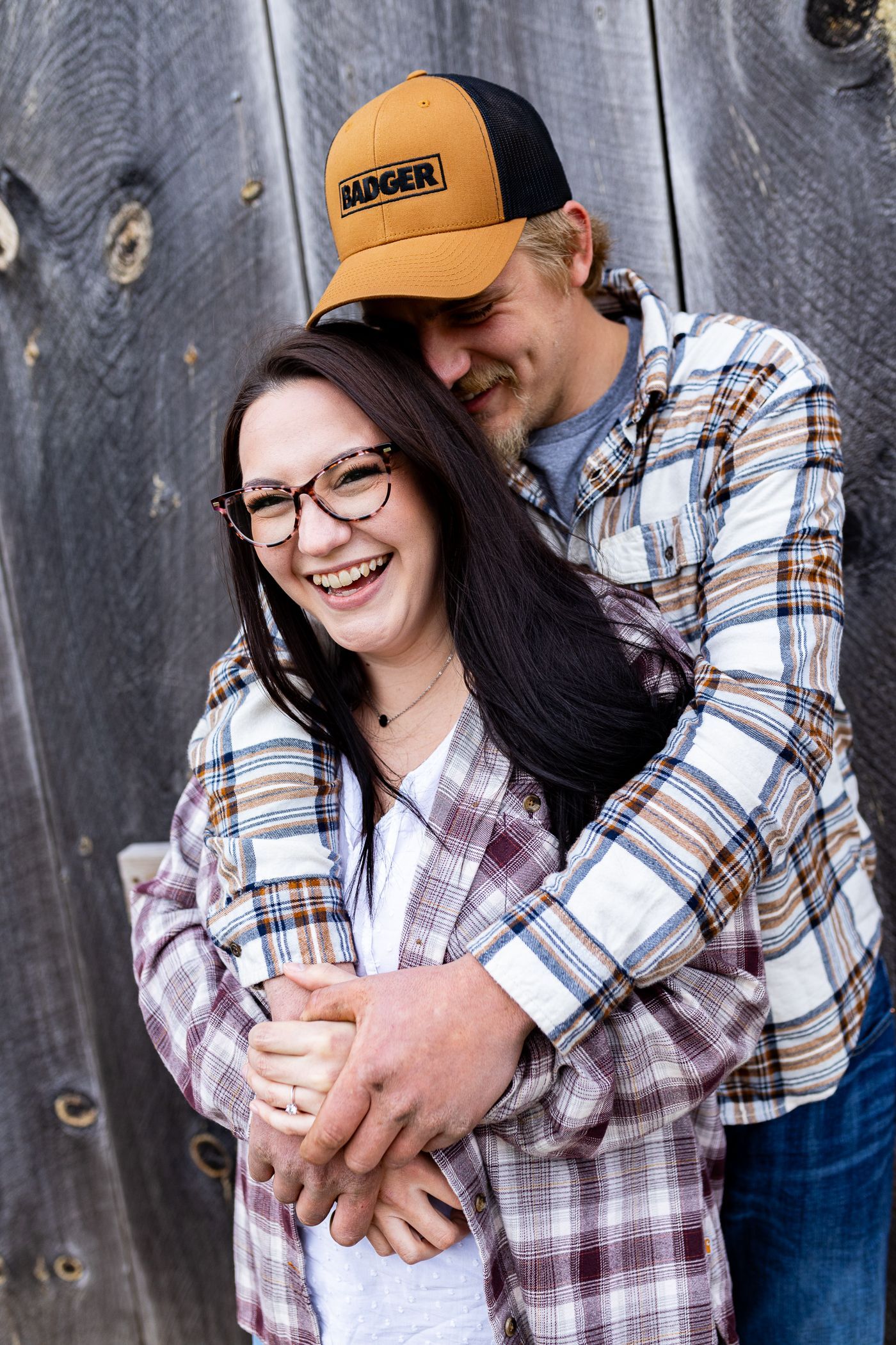 Man hugging woman from behind during engagement session