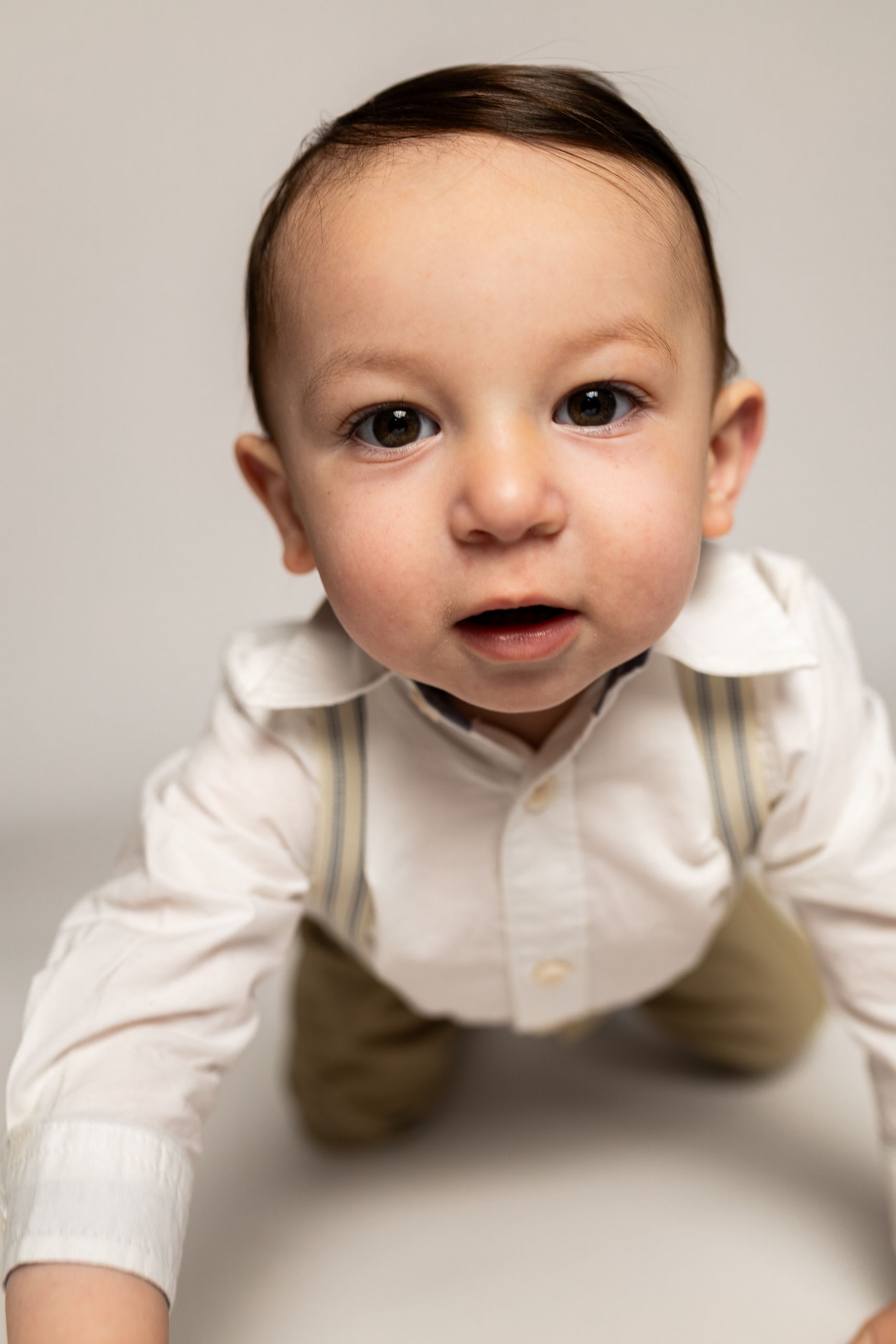 Baby posing on white background for cake smash session