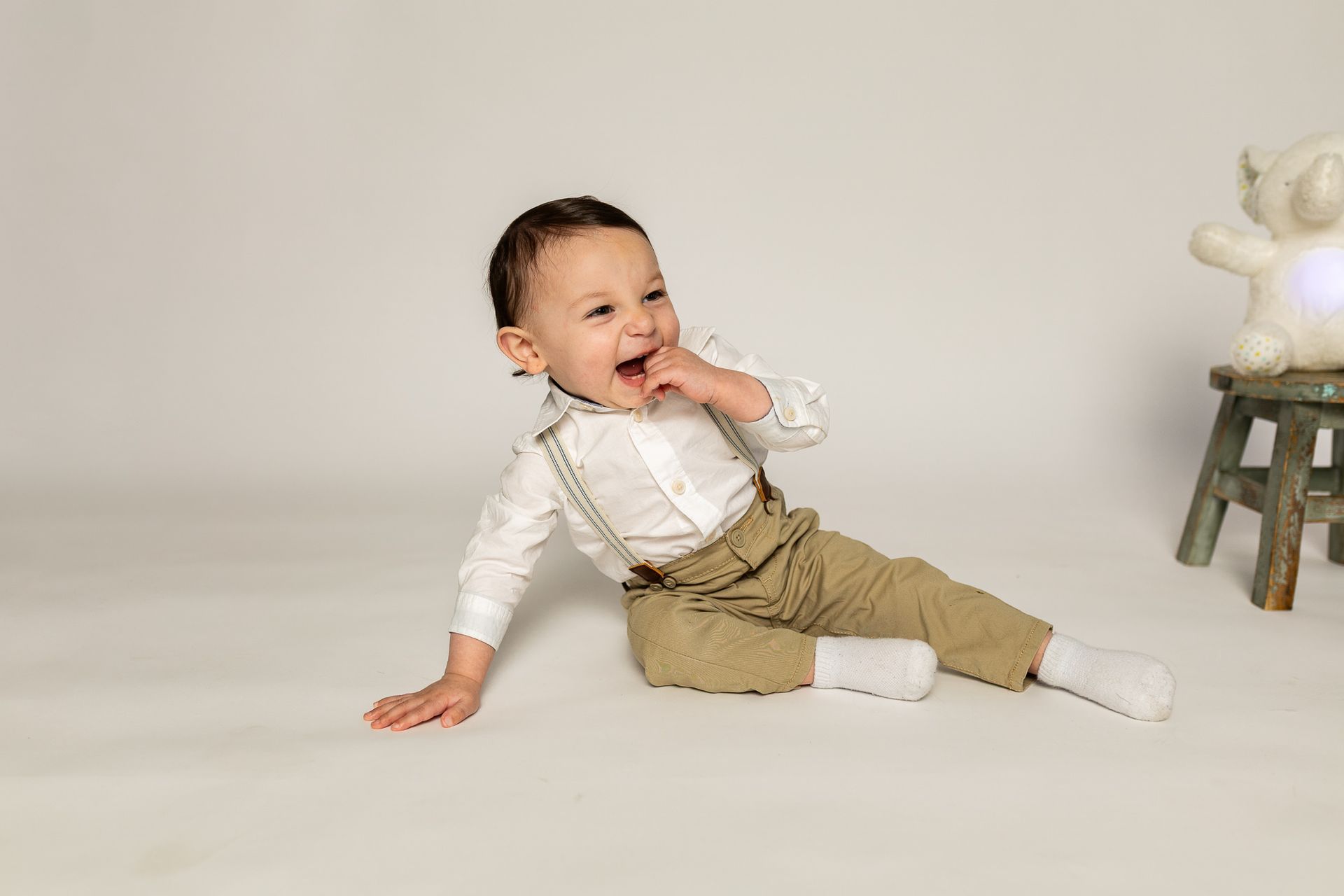 Baby posing on white background for cake smash session