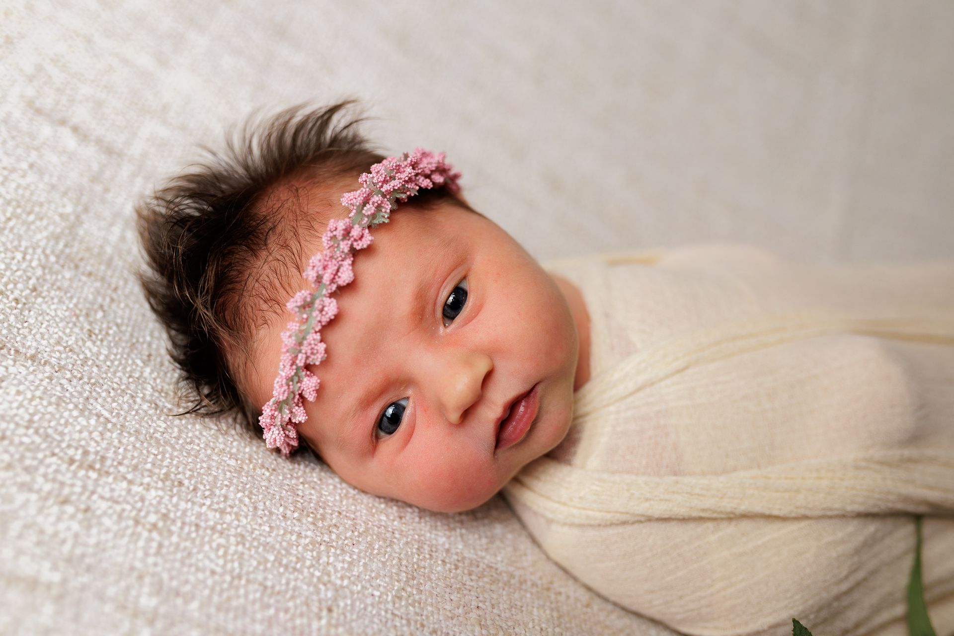 Newborn photography baby girl swaddled with flower crown