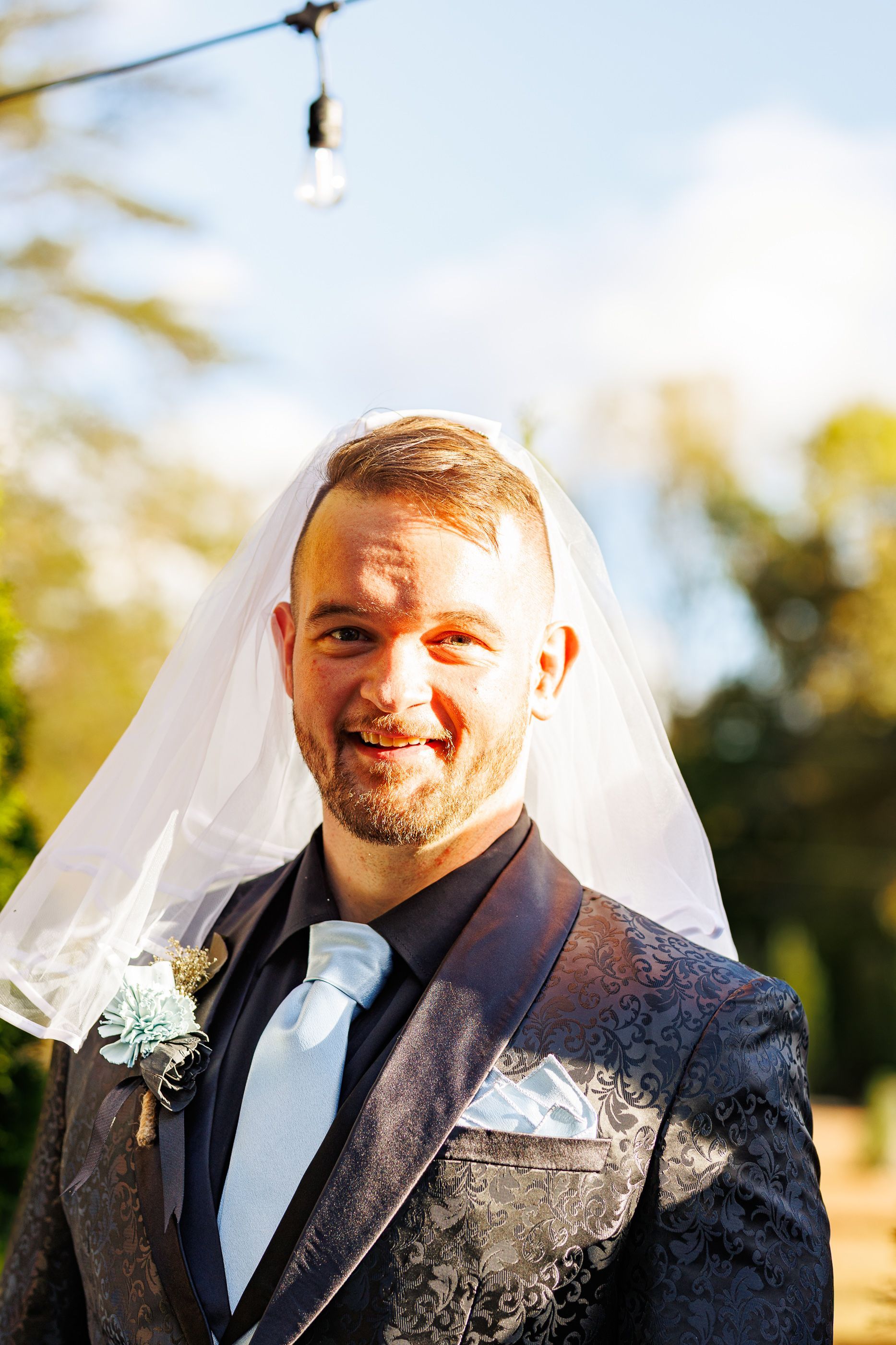 Groom wearing veil at Mariposa Chapel in Iron Station, NC