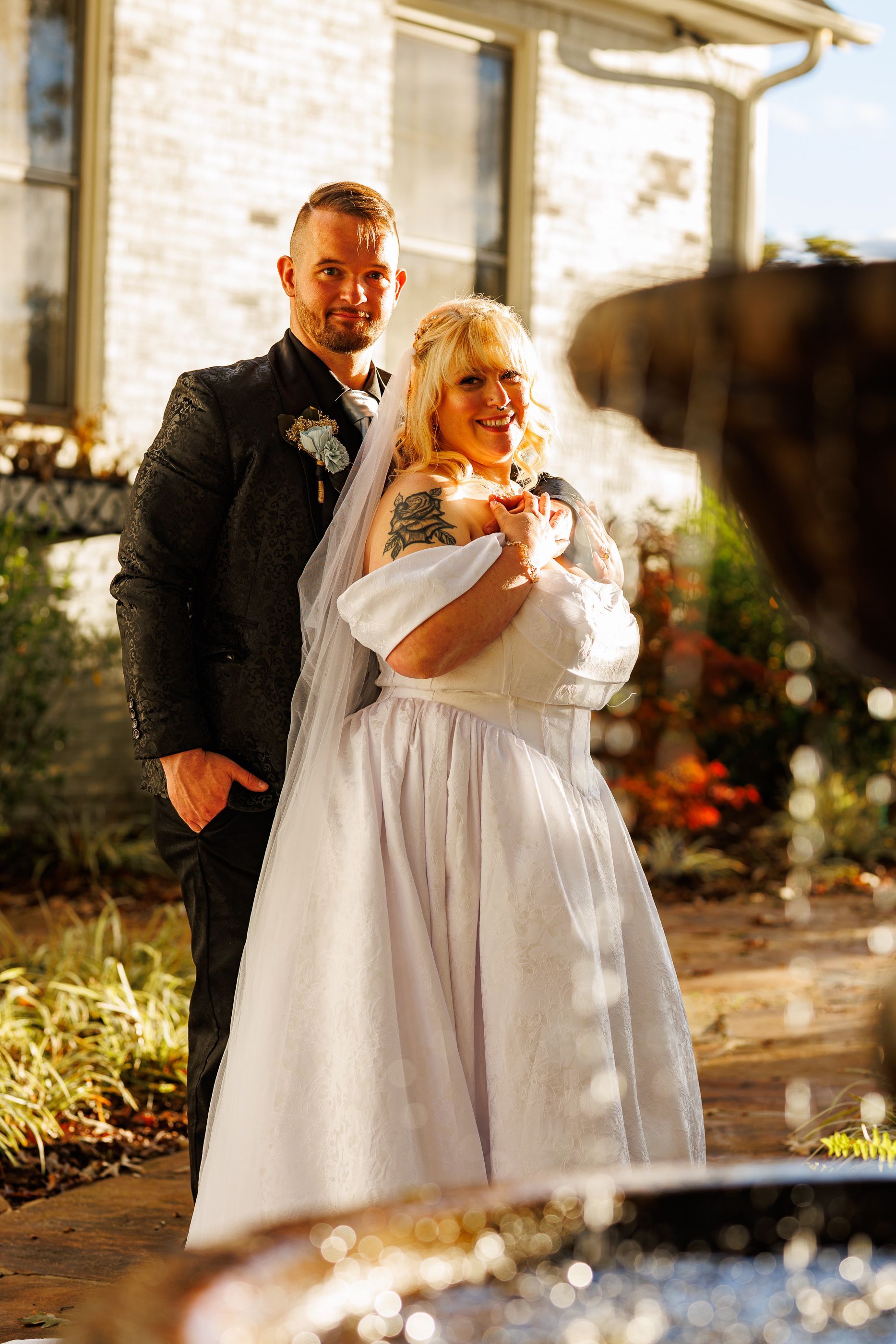Couple posing by water fountain at Mariposa Chapel in Iron Station, NC
