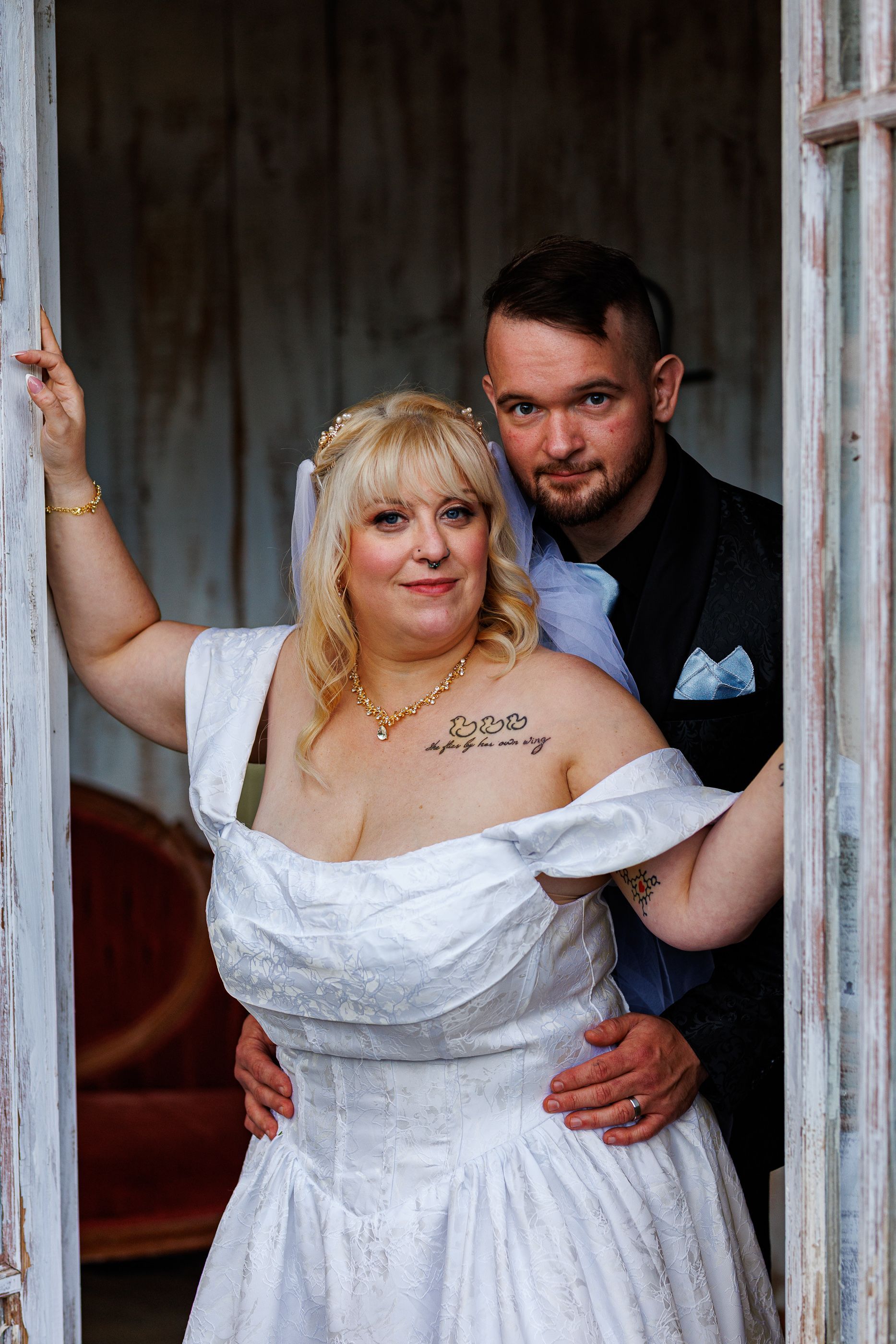 Couple posing in green house at Mariposa Chapel in Iron Station, NC