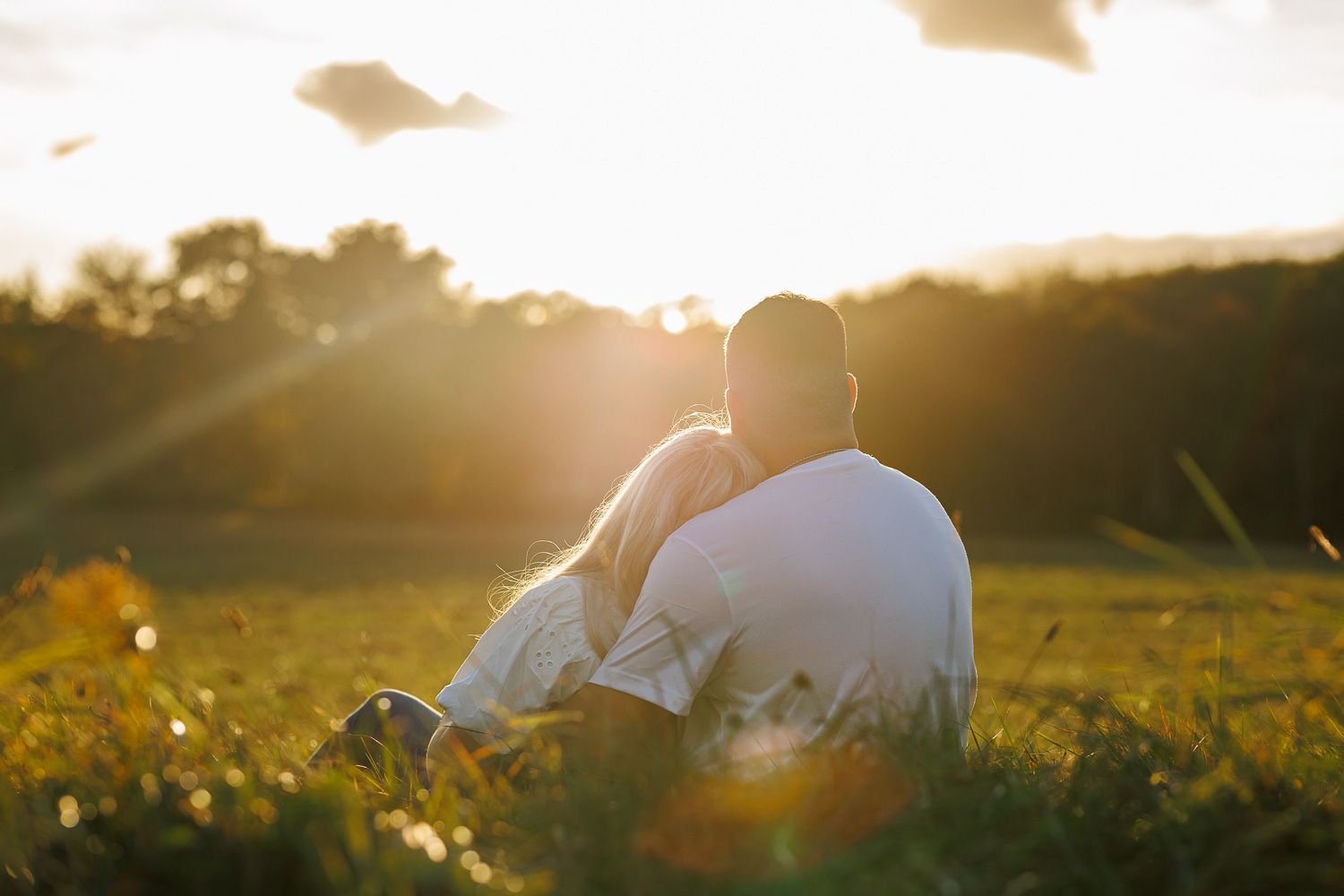 Picnic themed engagement session with couple snuggling