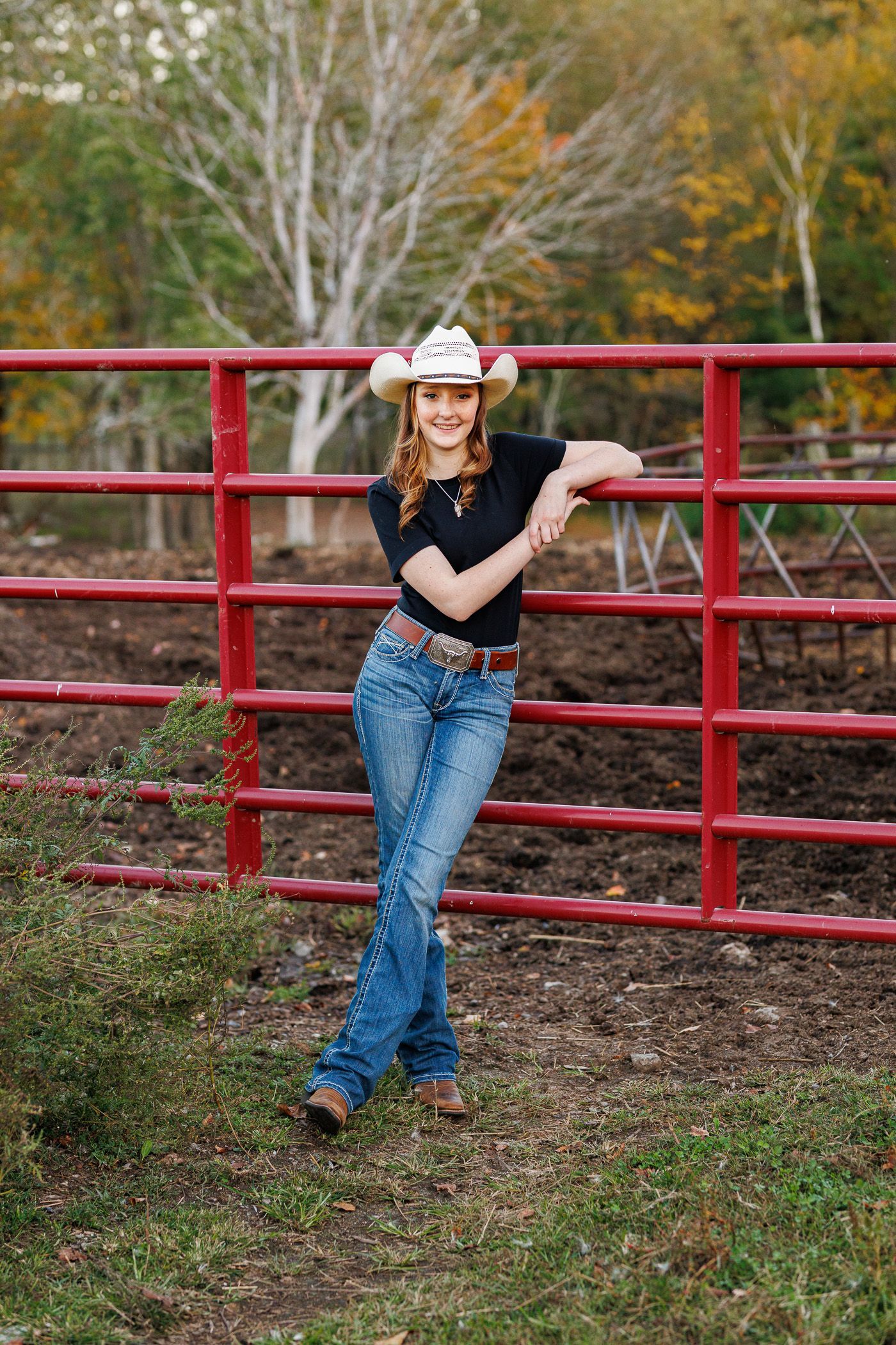High school senior - senior photography - female student posing on cattle fence