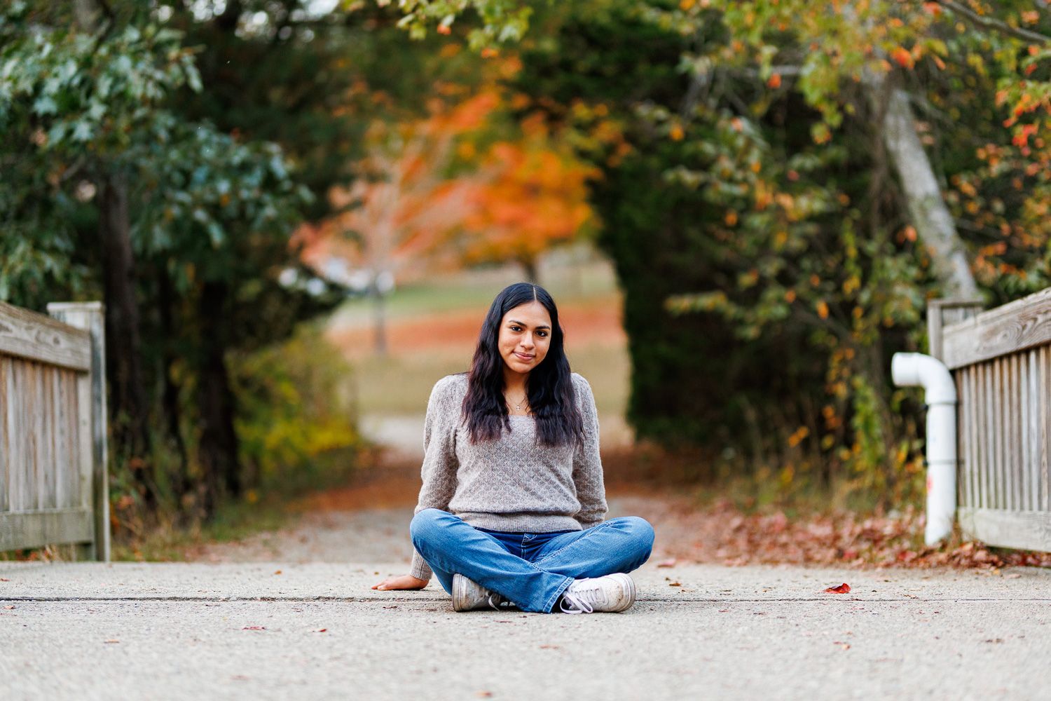 High school senior - senior photography - female student sitting on bridge