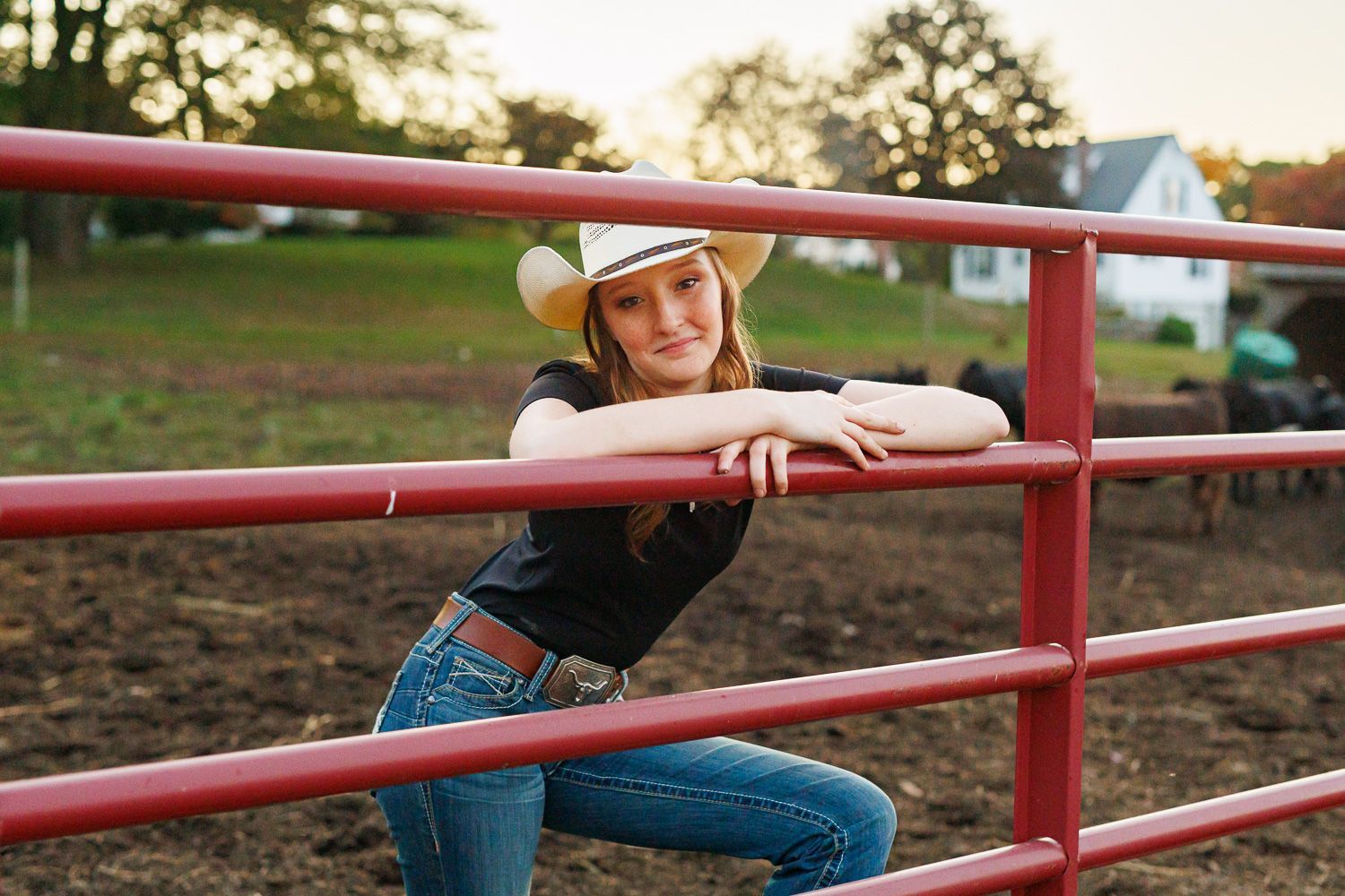 High school senior - senior photography - female student posing on cattle fence