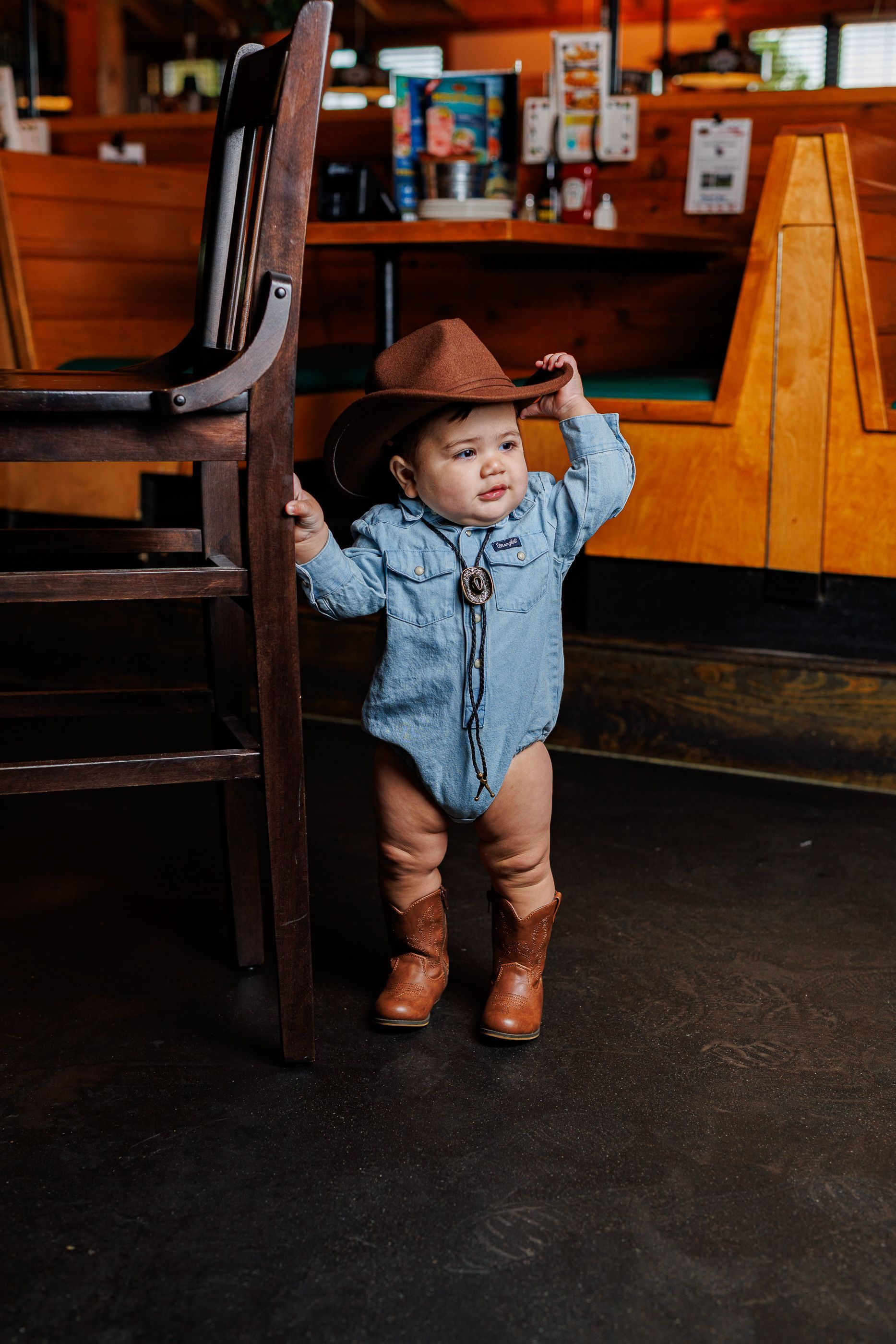 Baby posing at Texas Roadhouse for a cowboy steak smash session