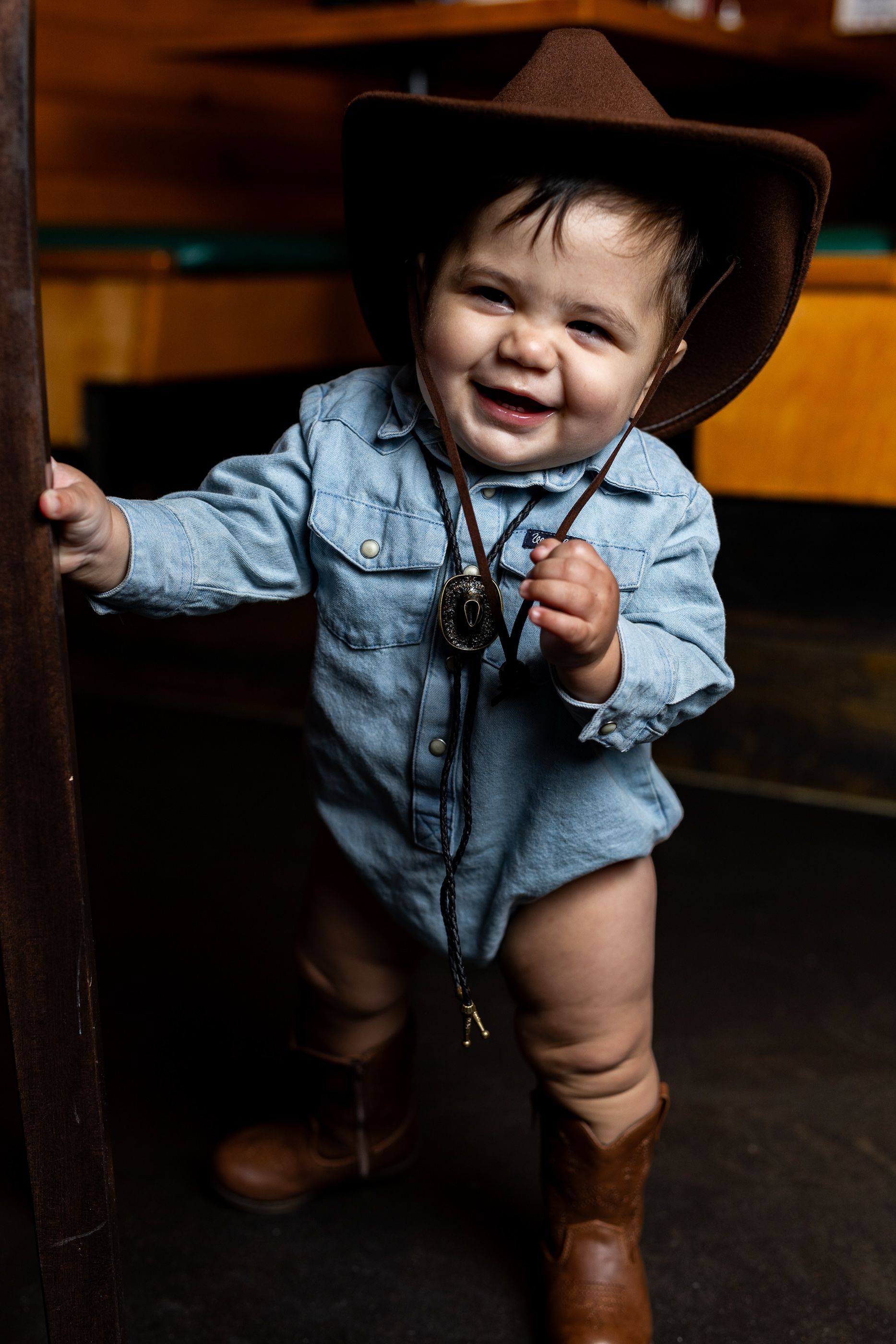 Baby posing at Texas Roadhouse for a cowboy steak smash session