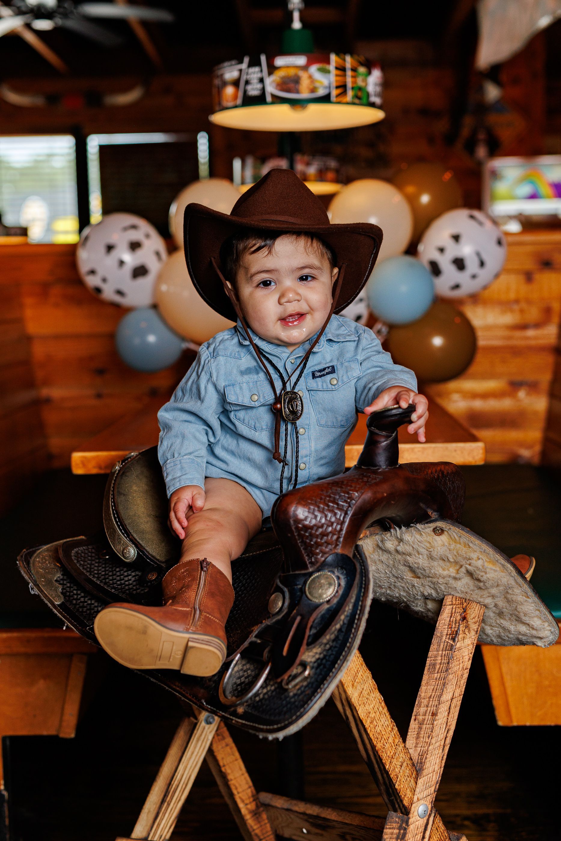 Baby posing at Texas Roadhouse for a cowboy steak smash session