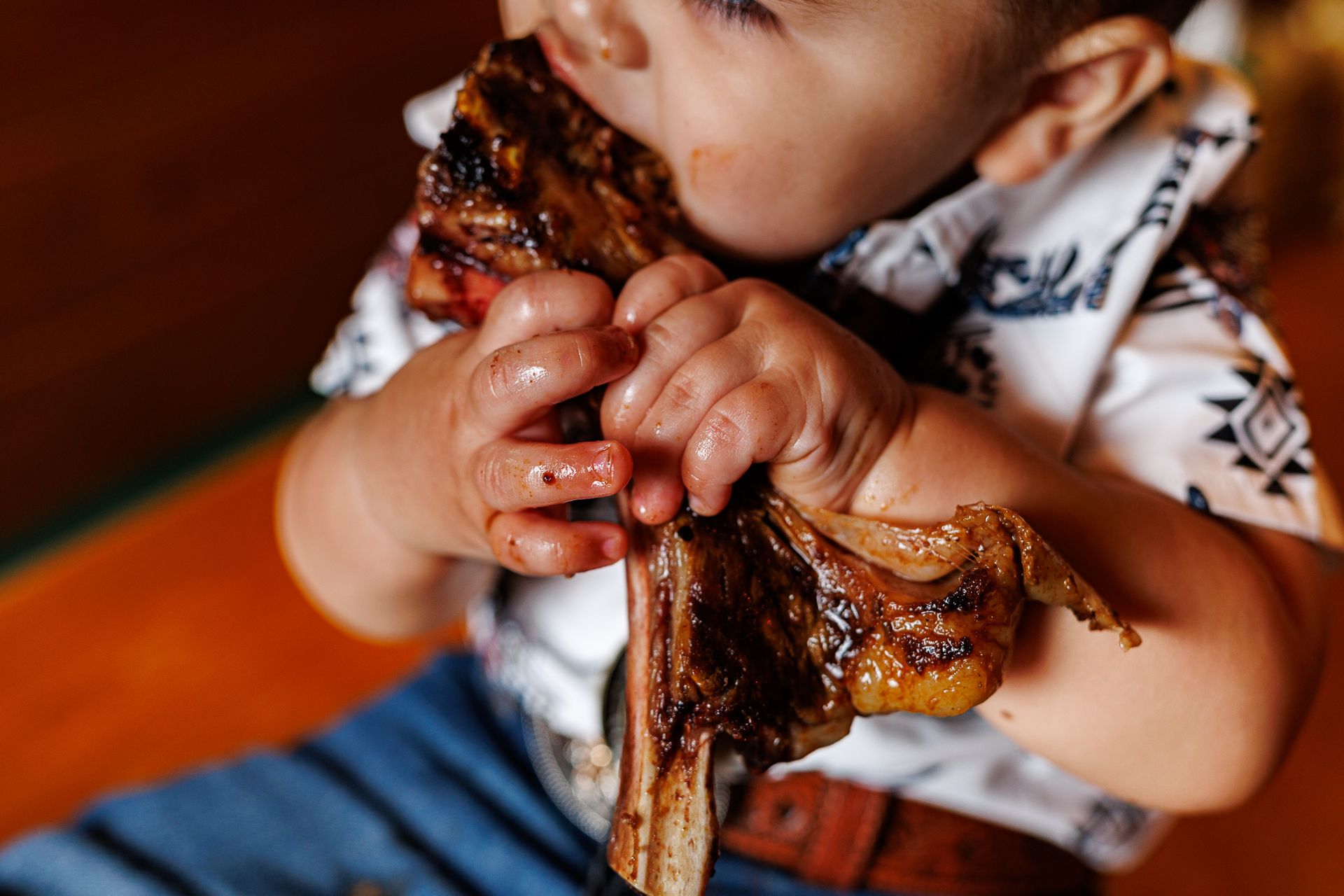 Baby eating steak at Texas Roadhouse for a cowboy steak smash session