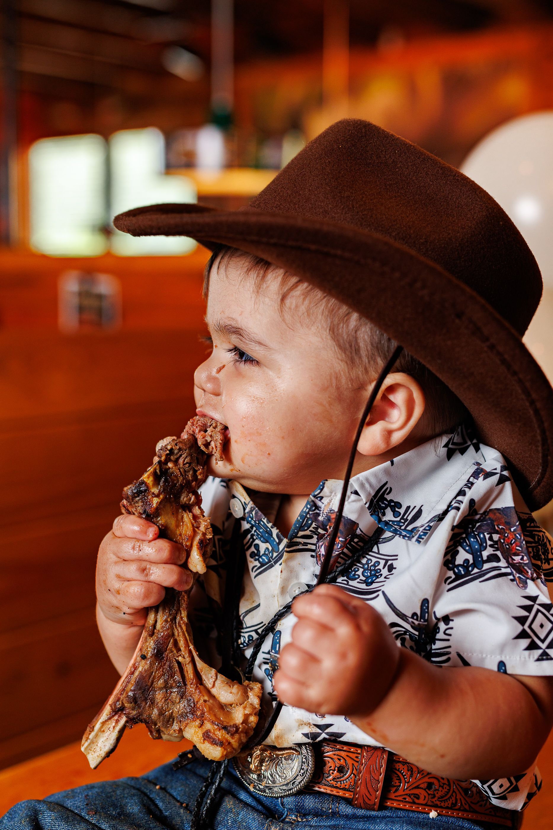 Baby eating steak at Texas Roadhouse for a cowboy steak smash session