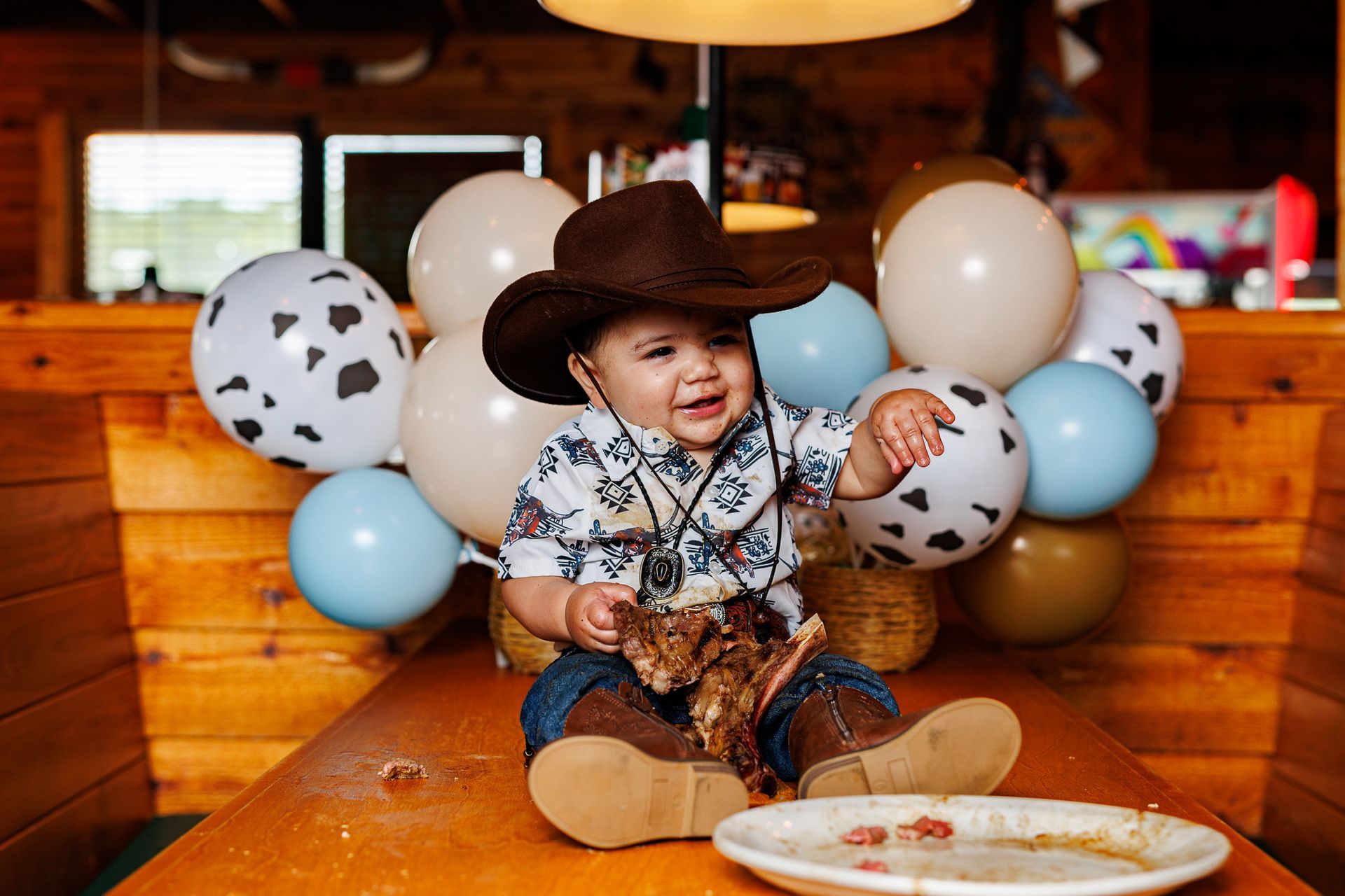 Baby eating steak at Texas Roadhouse for a cowboy steak smash session