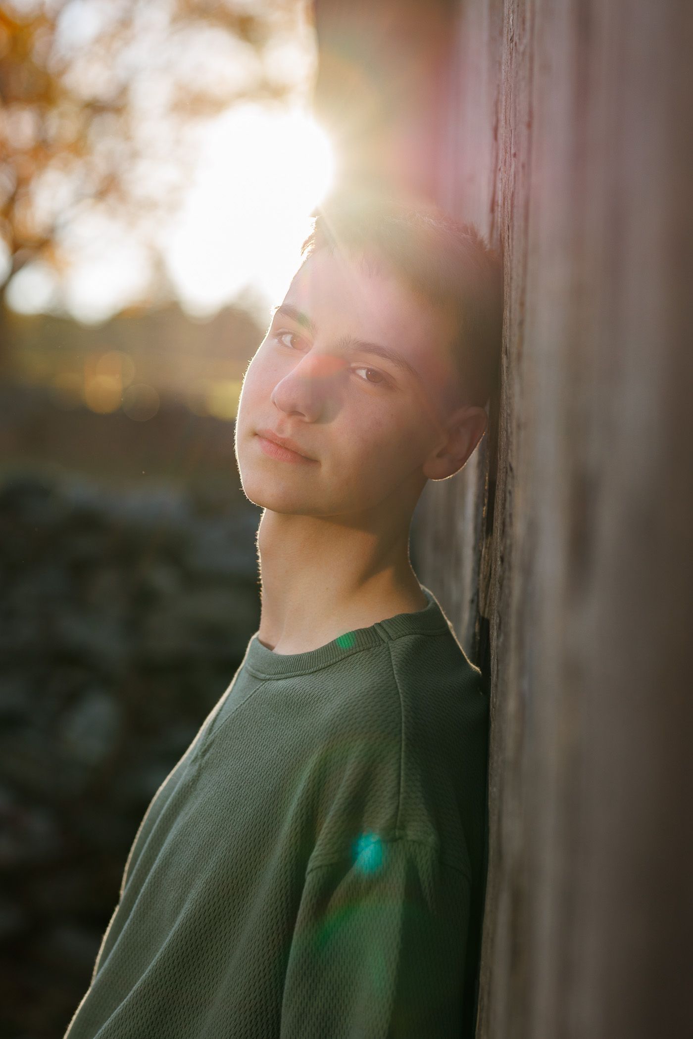 High school senior - senior photography - male student leaning against building