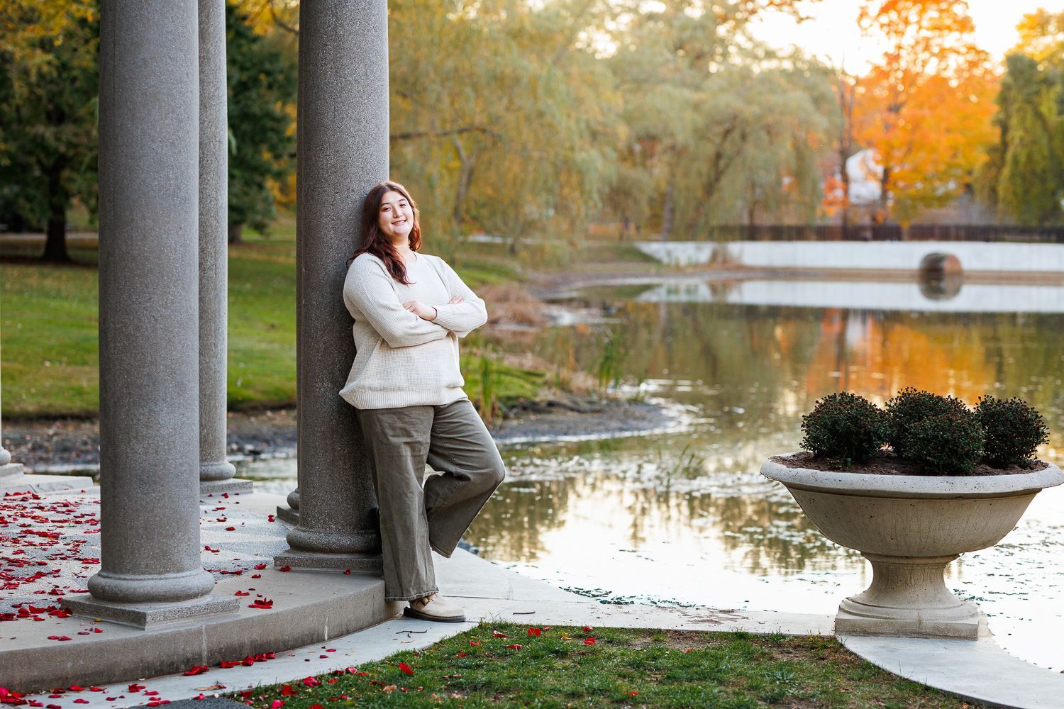 High school senior - senior photography - female student leaning against stone pillar