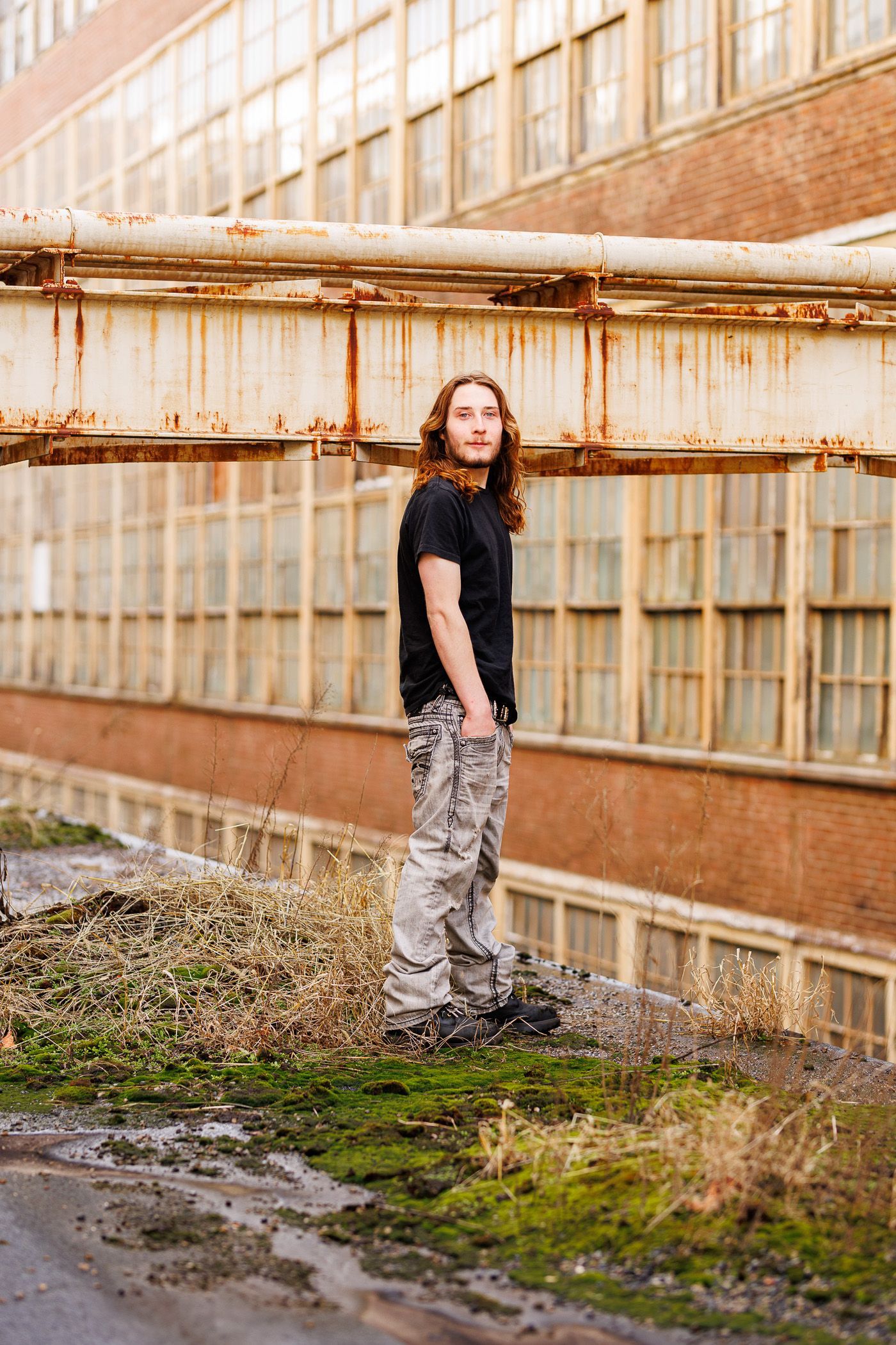 High school senior - senior photography - male student standing on top of building