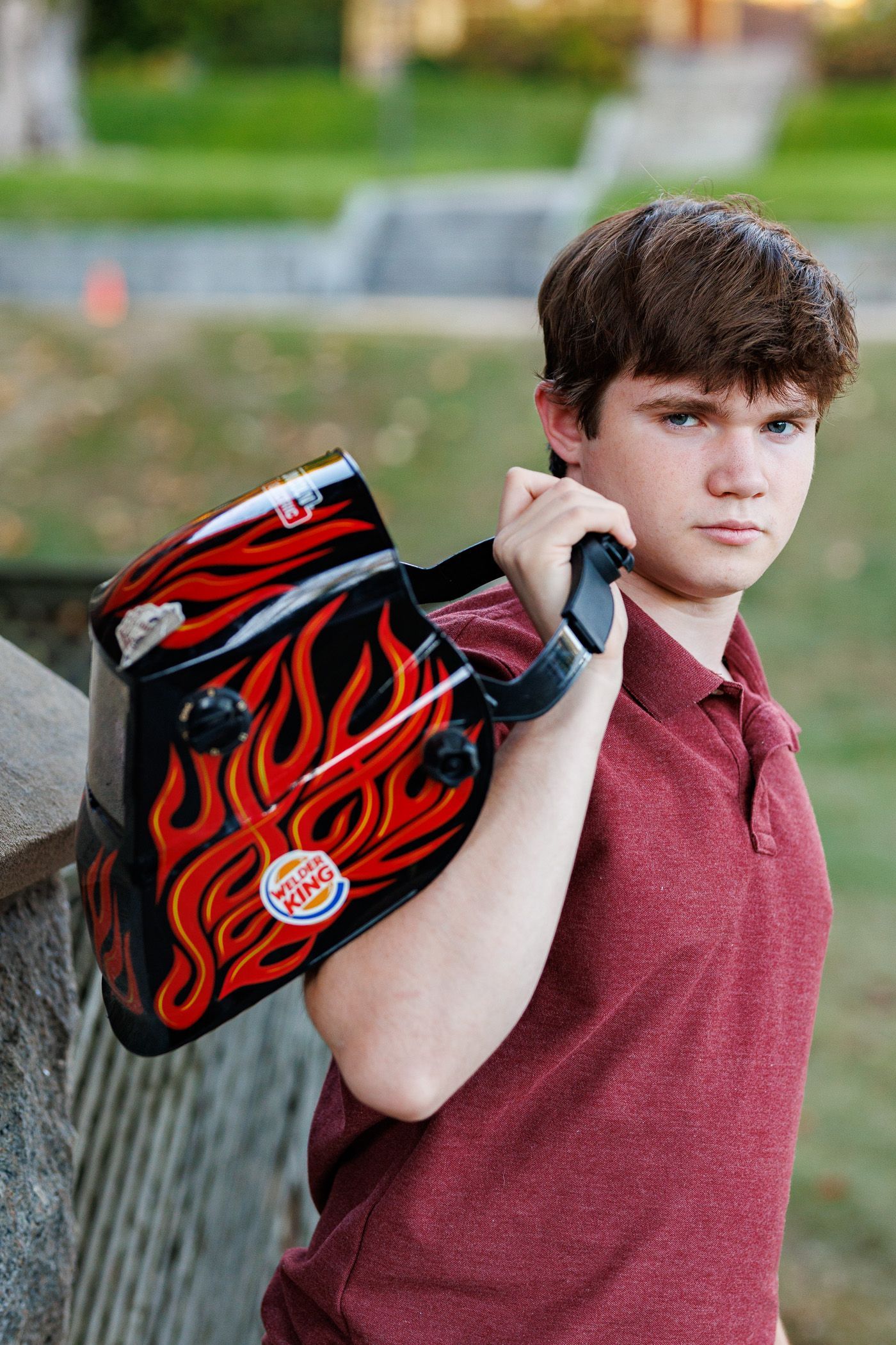 High school senior - senior photography - male student standing with welding helmet