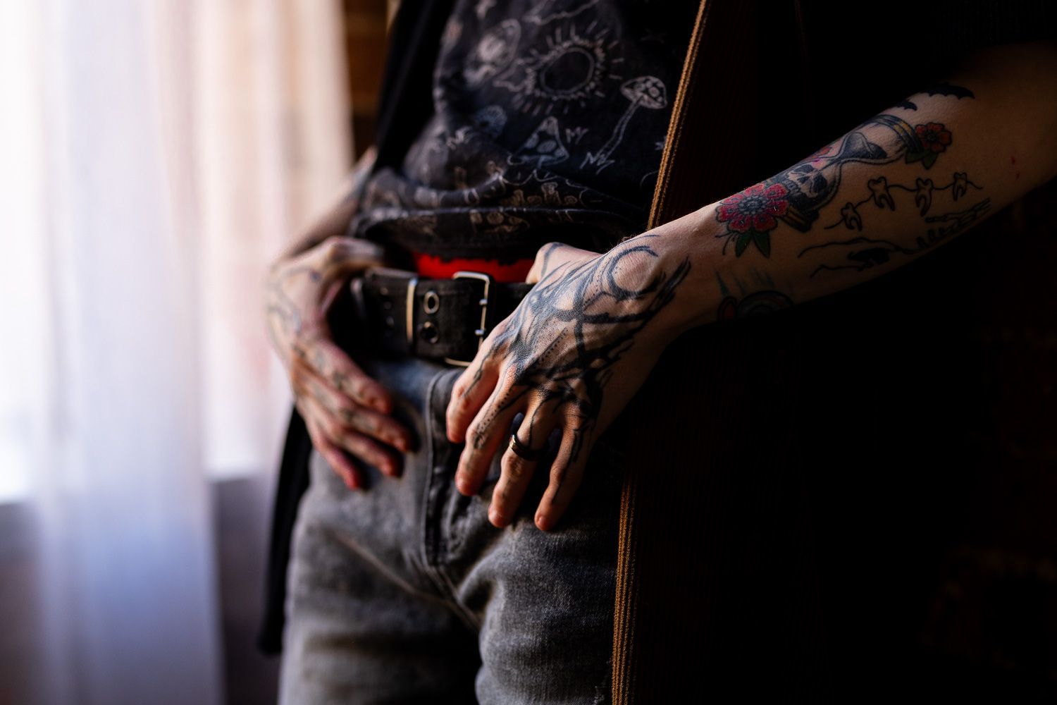 Man holding belt for masculine inspired boudoir session