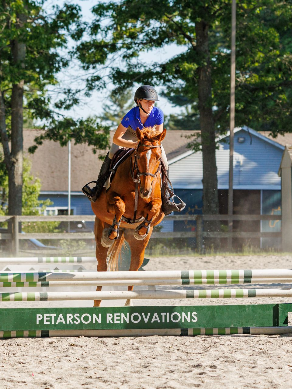 equestrian photography - young girl winning a horse competition in a blue shirt on her brown horse
