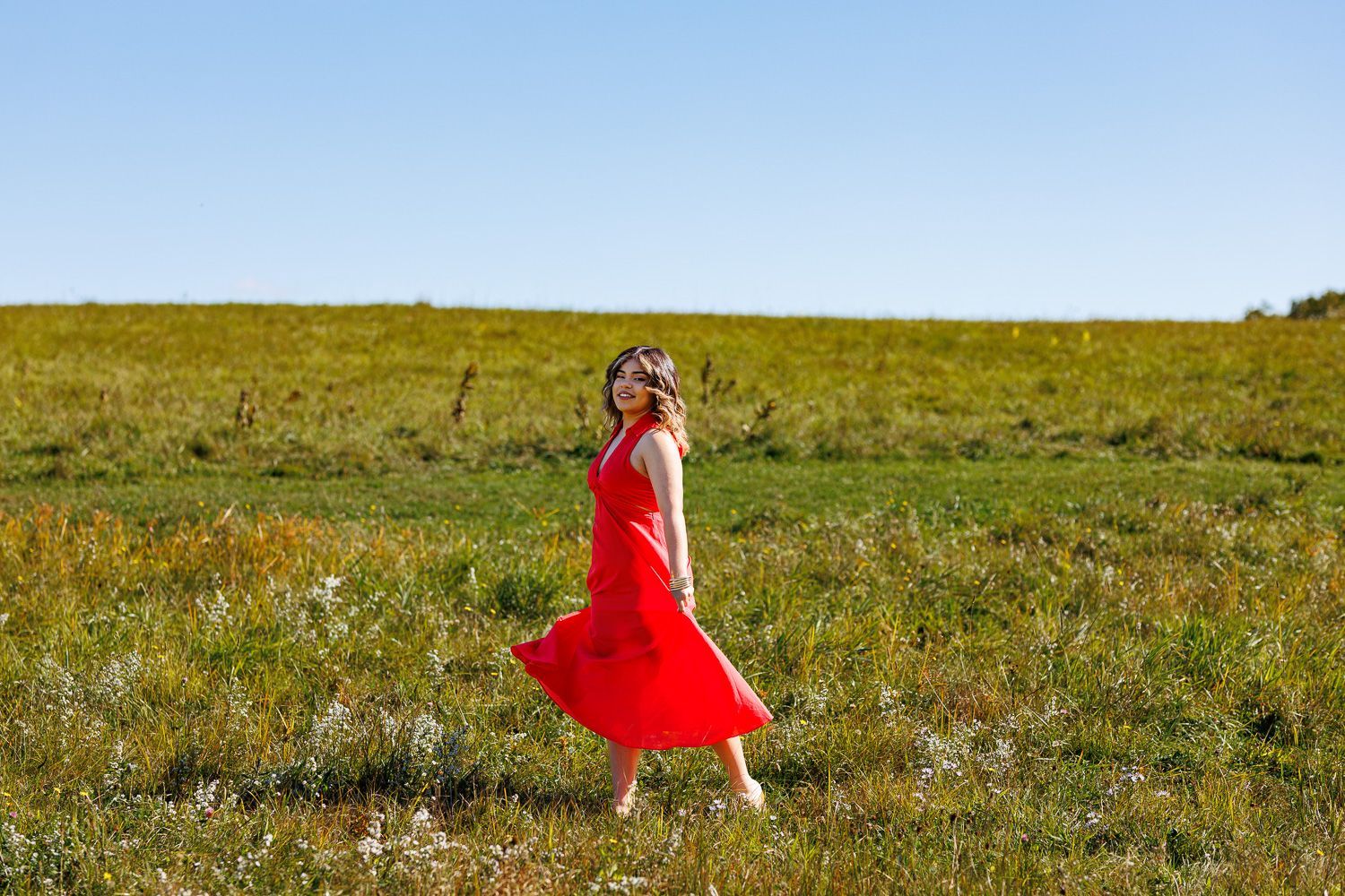 High school senior - senior photography - female student twirling dress in field