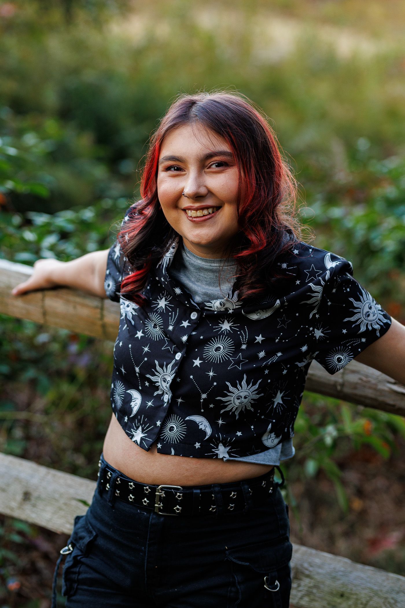 High school senior - senior photography - female student leaning on fence line