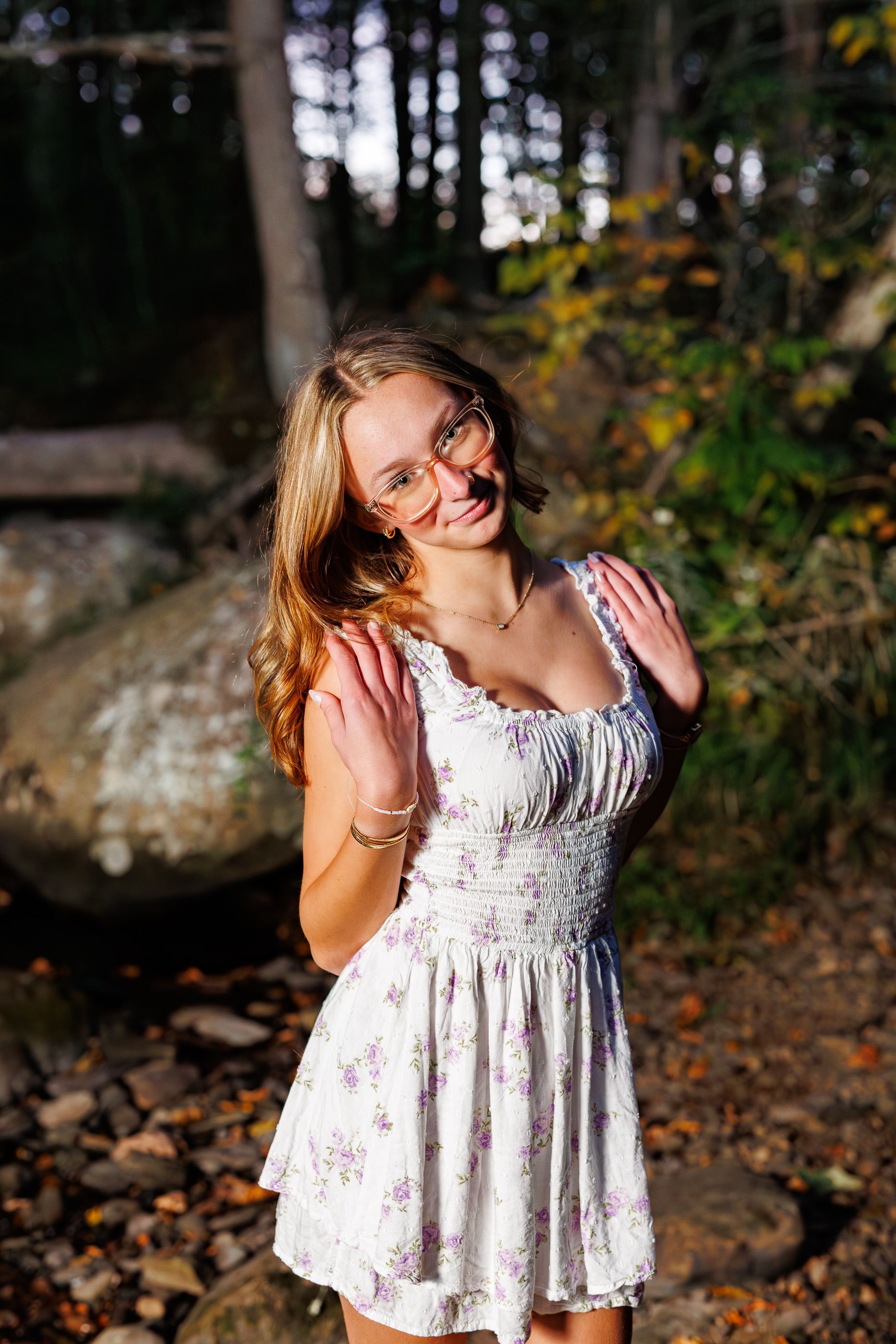 High school senior - senior photography - female student sitting in river at dusk