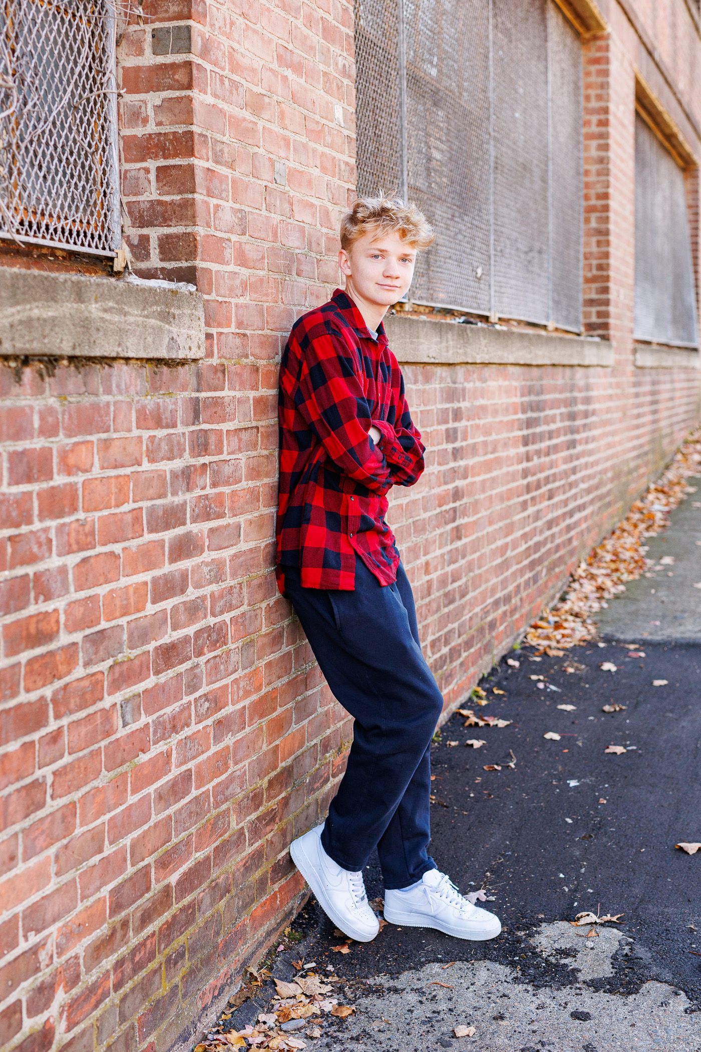 High school senior - senior photography - male student posing in industrial setting