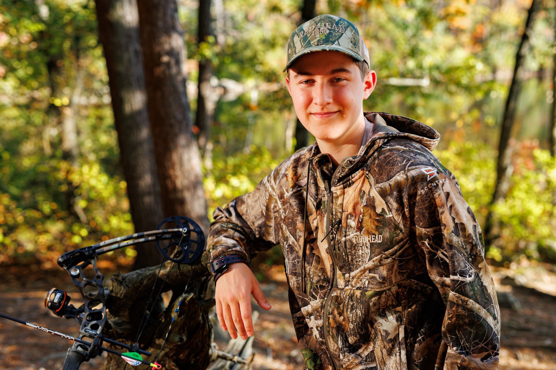 High school senior - senior photography - male student with bow and arrow in camo