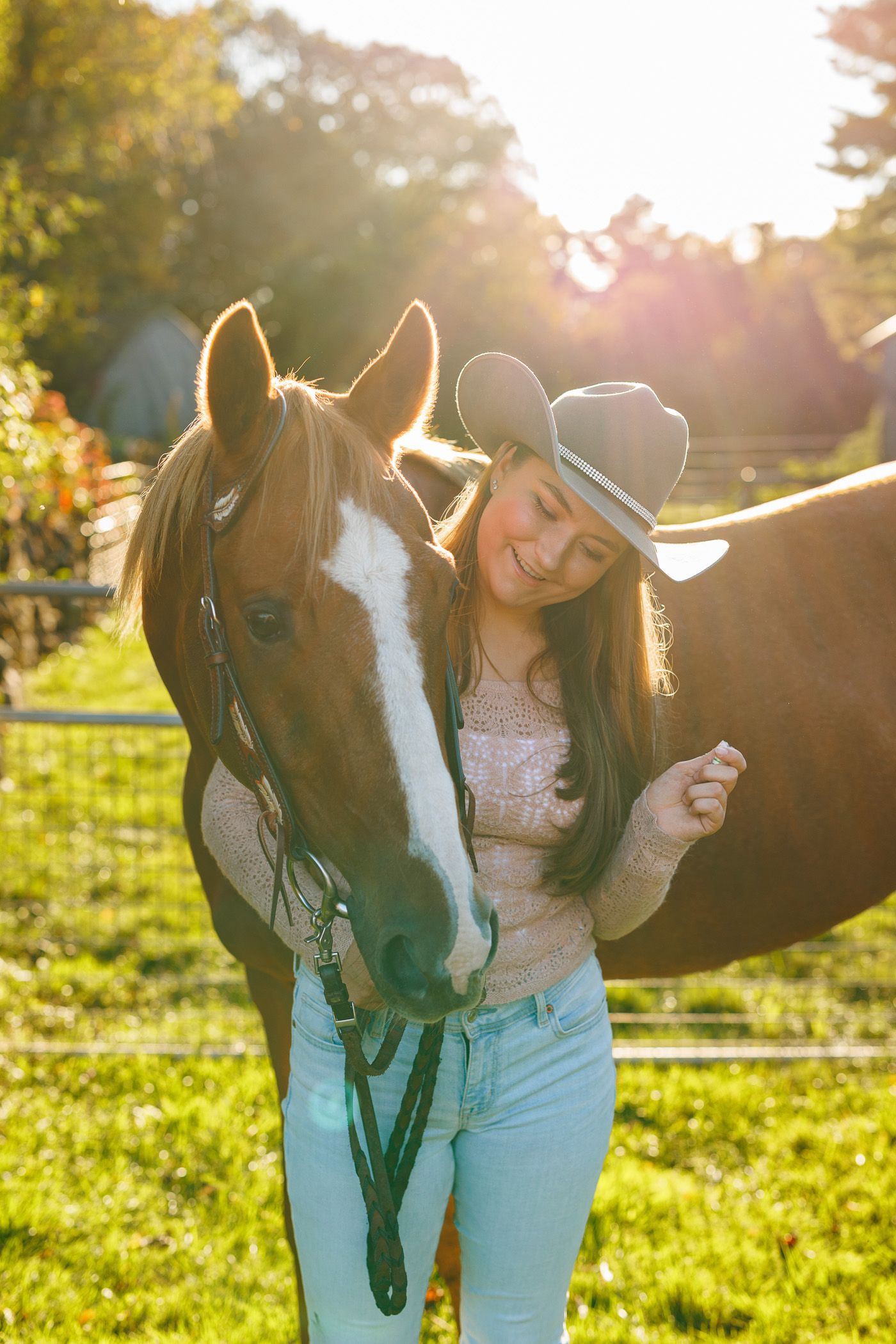High school senior - senior photography - female student posing with cowboy hat and horse at sunset
