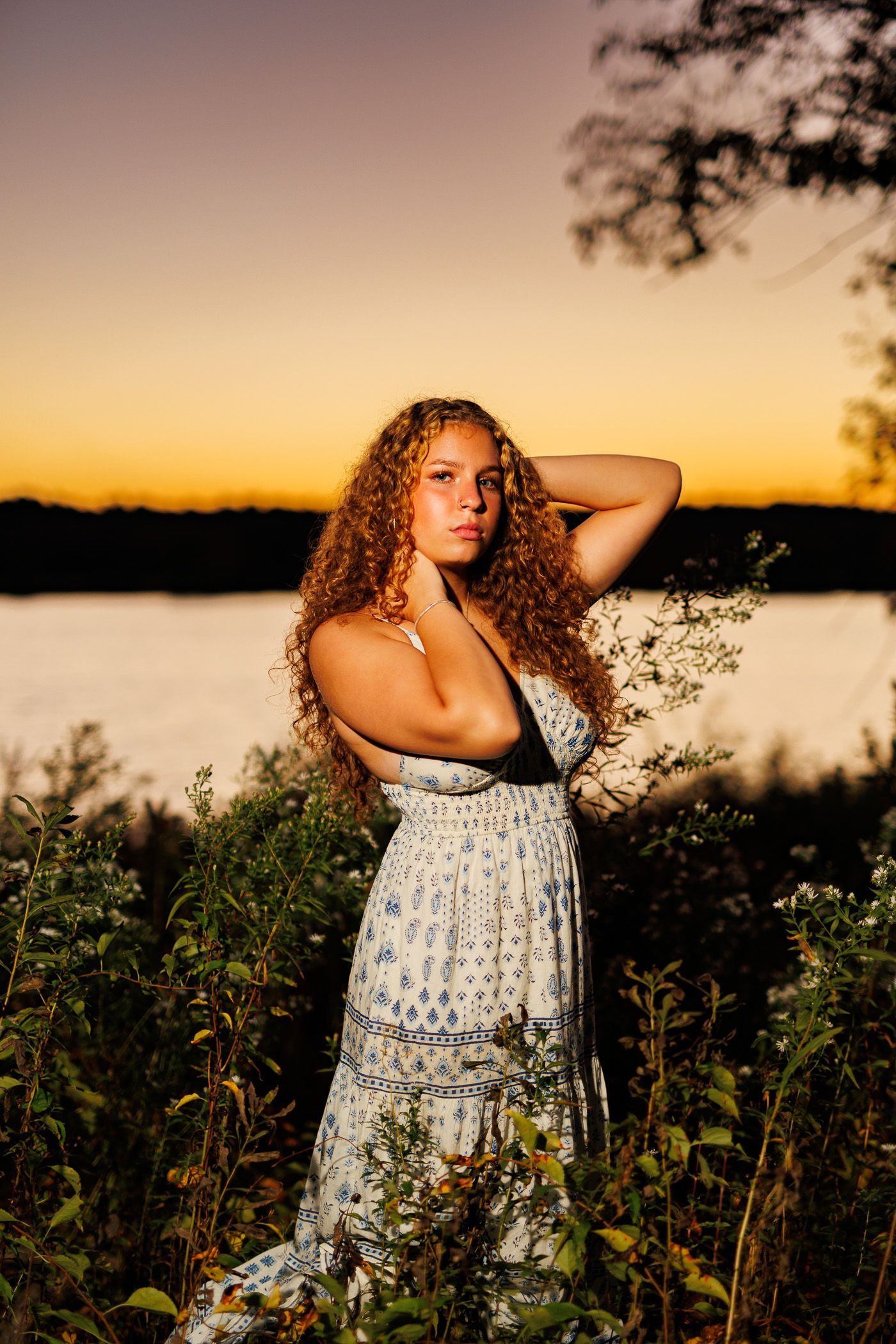 High school senior - senior photography - female student posing in front of sunset