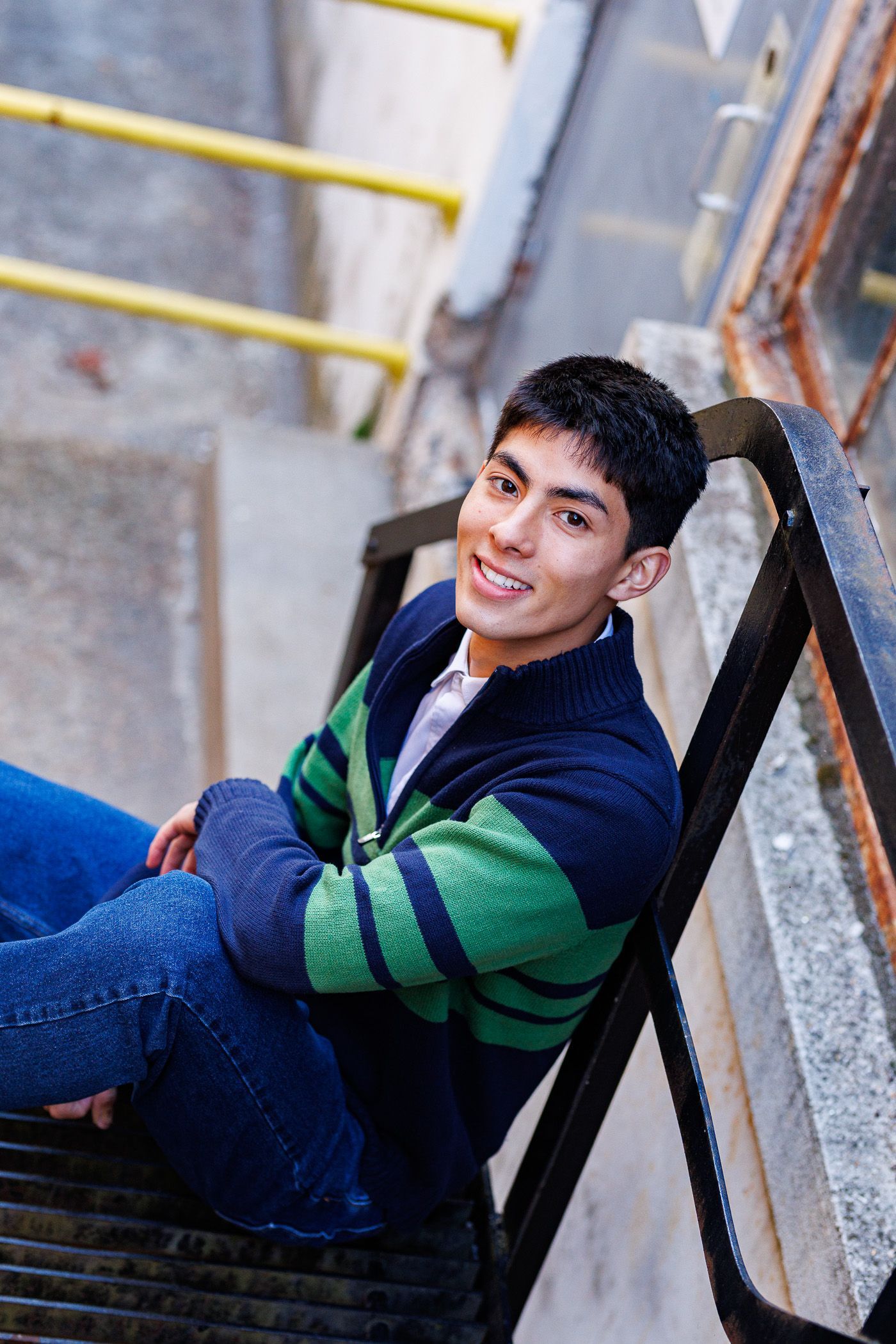 High school senior - senior photography - male student sitting on industrial stairs