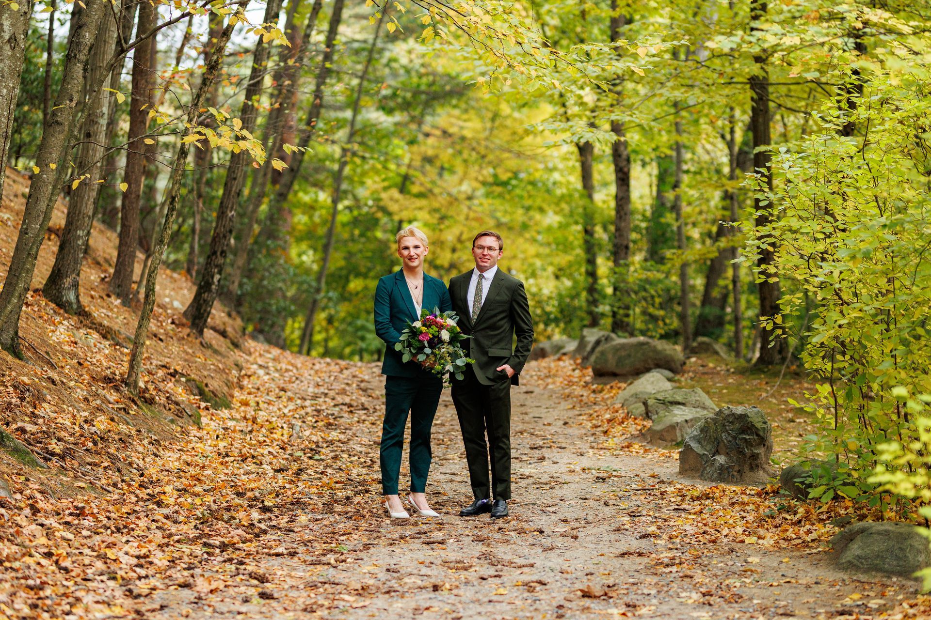 Gay couple posing on wooded trail