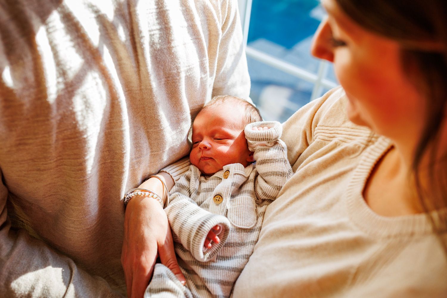 Newborn photography baby being snuggled by parents