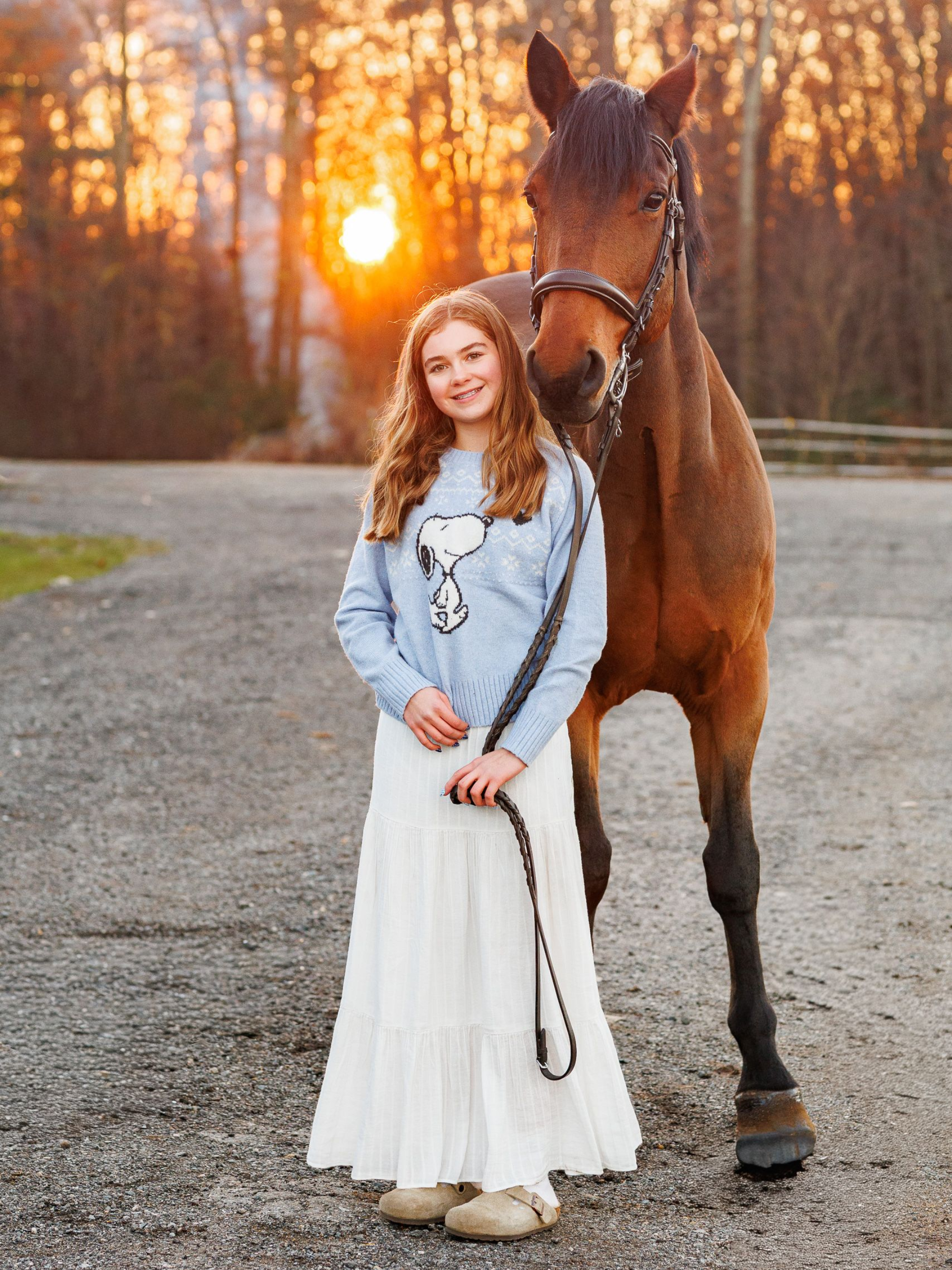 equestrian photography - woman posing with brown horse for formal portraits