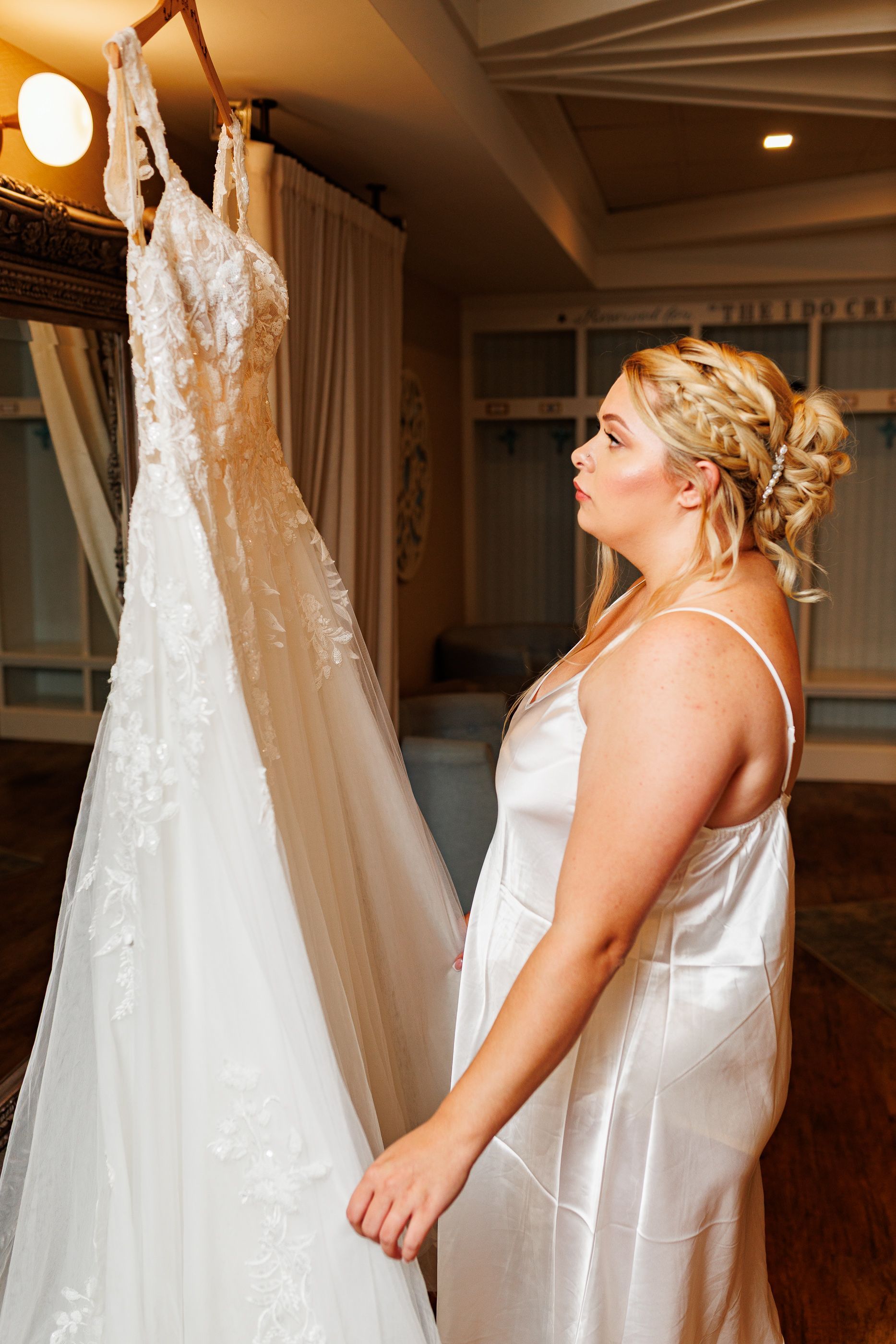 bride admiring her dress before wedding at Oceanview, Nahant, MA
