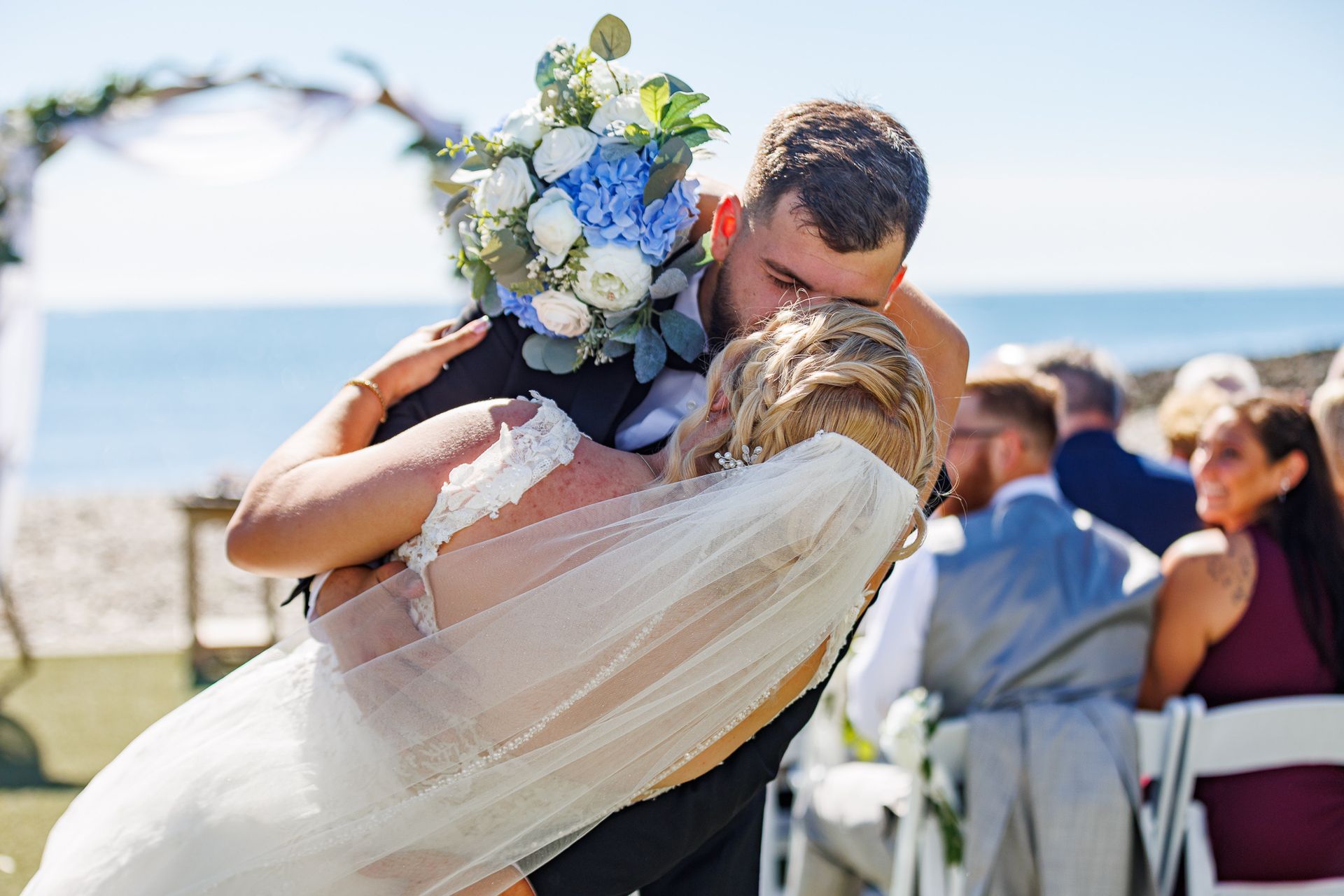 bride and groom dip kissing during wedding at Oceanview, Nahant, MA