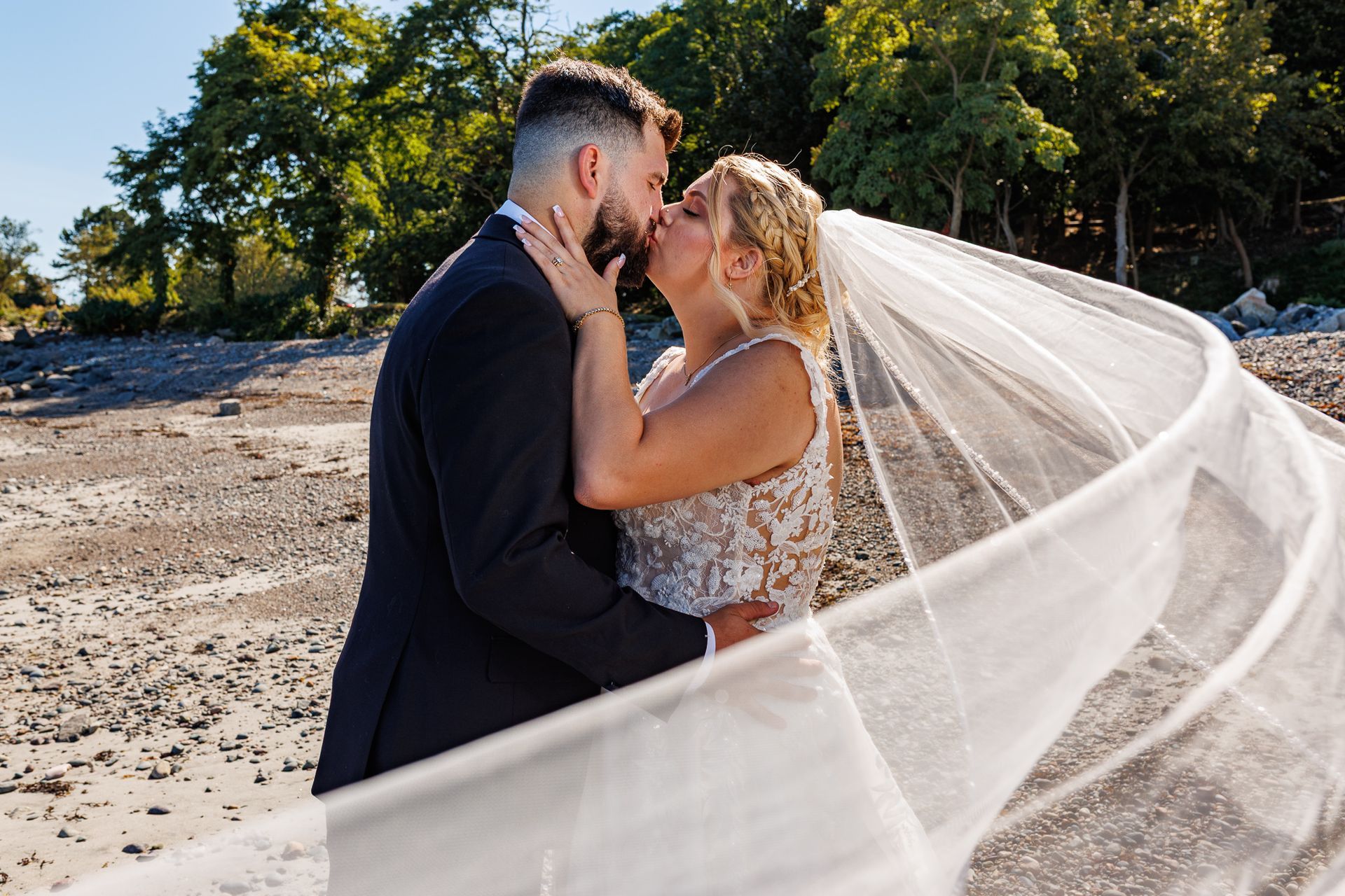 bride and groom kissing on the beach during wedding at Oceanview, Nahant, MA