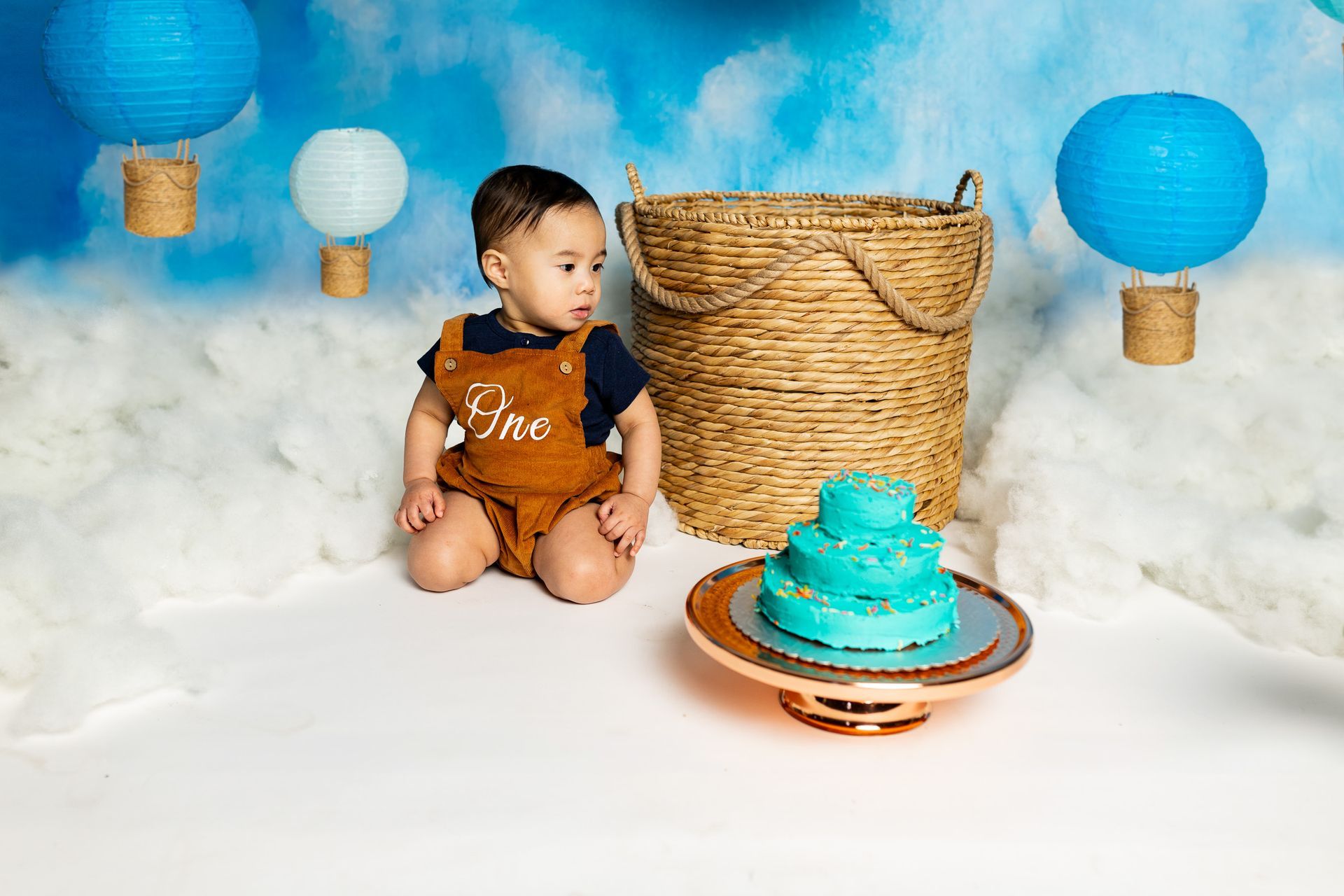 baby on a hot air balloon themed set for cake smash session