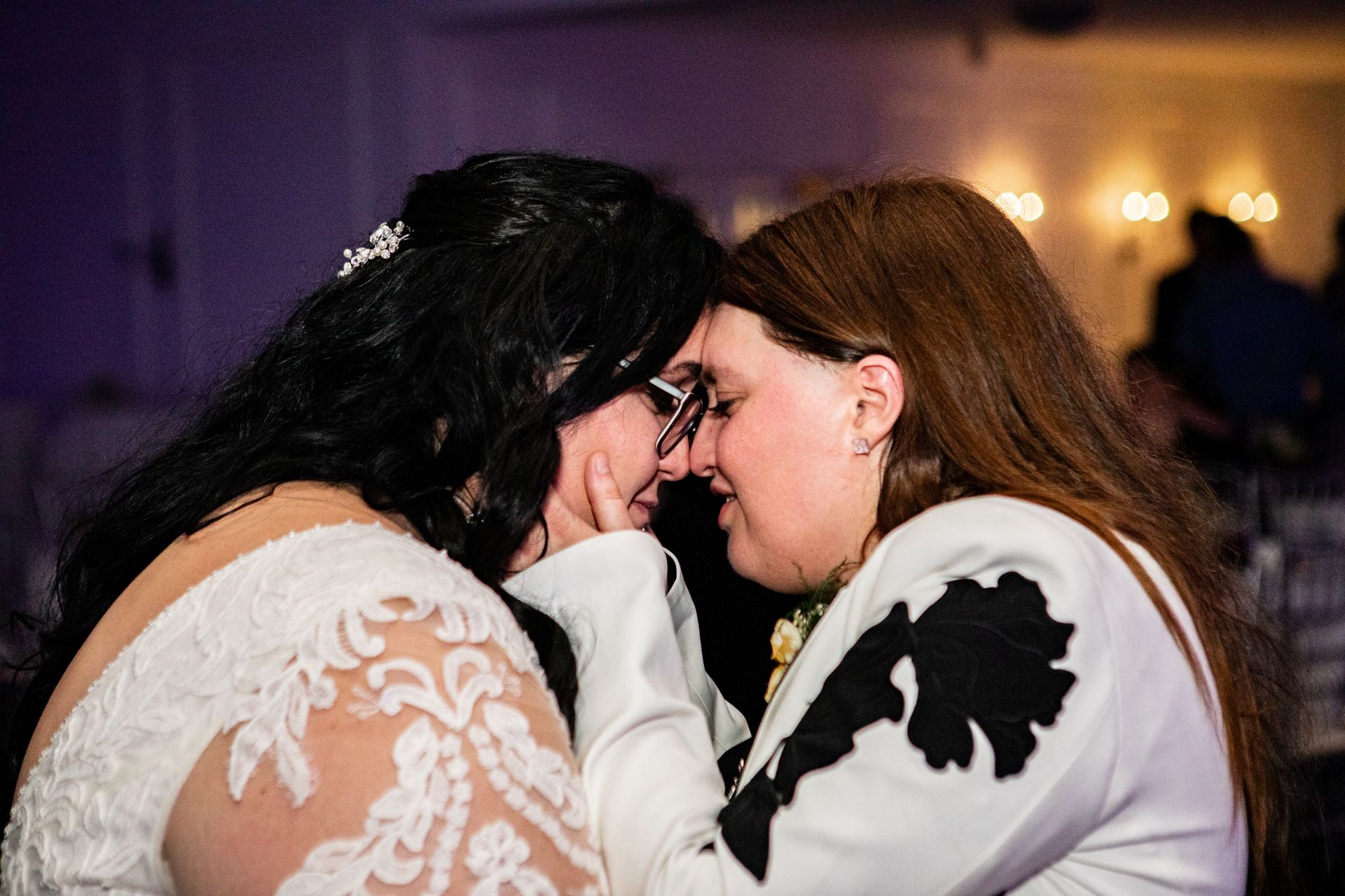 Lesbian couple embracing at their wedding at Black Swan Country Club