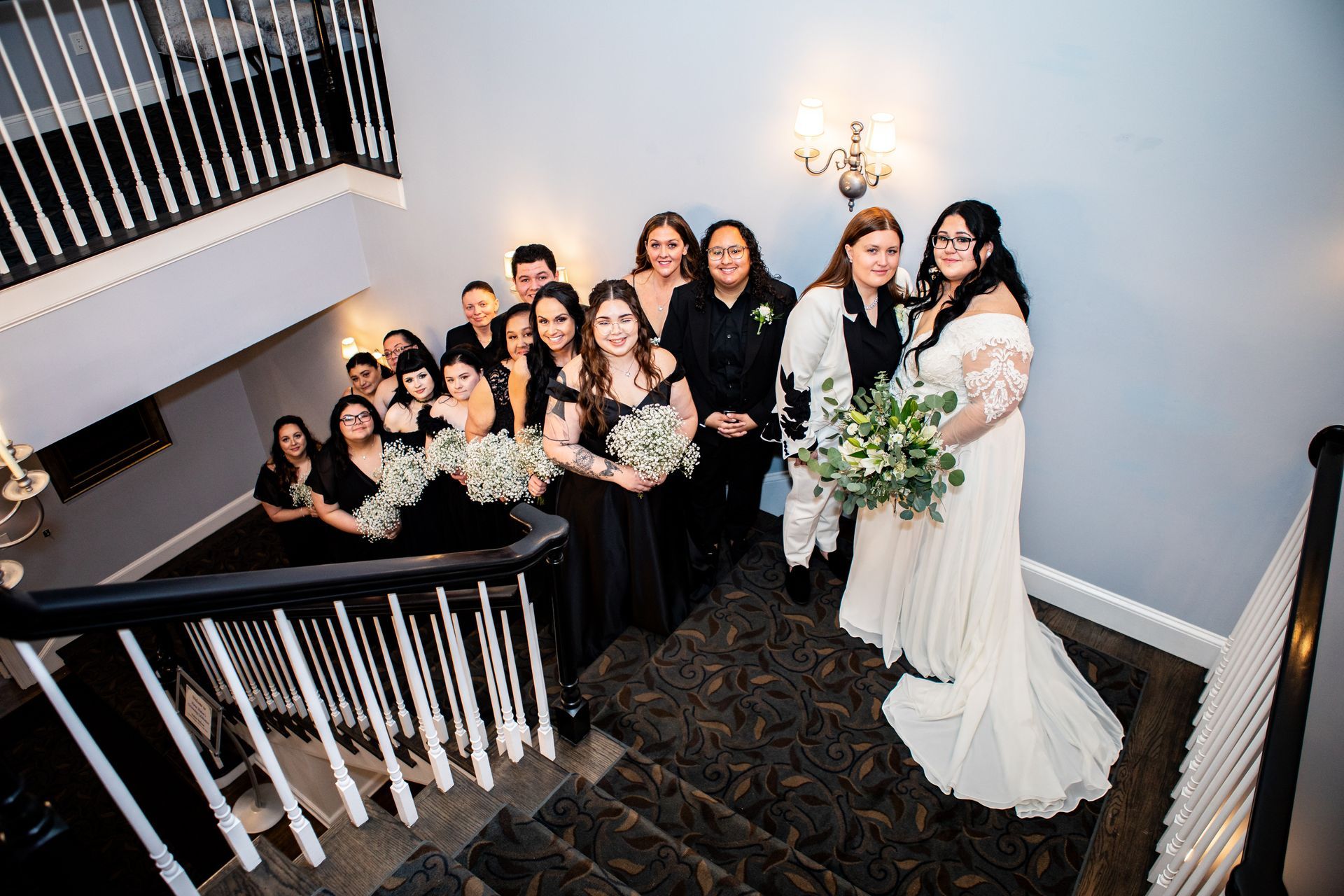 Lesbian couple posing with their wedding party at Black Swan Country Club