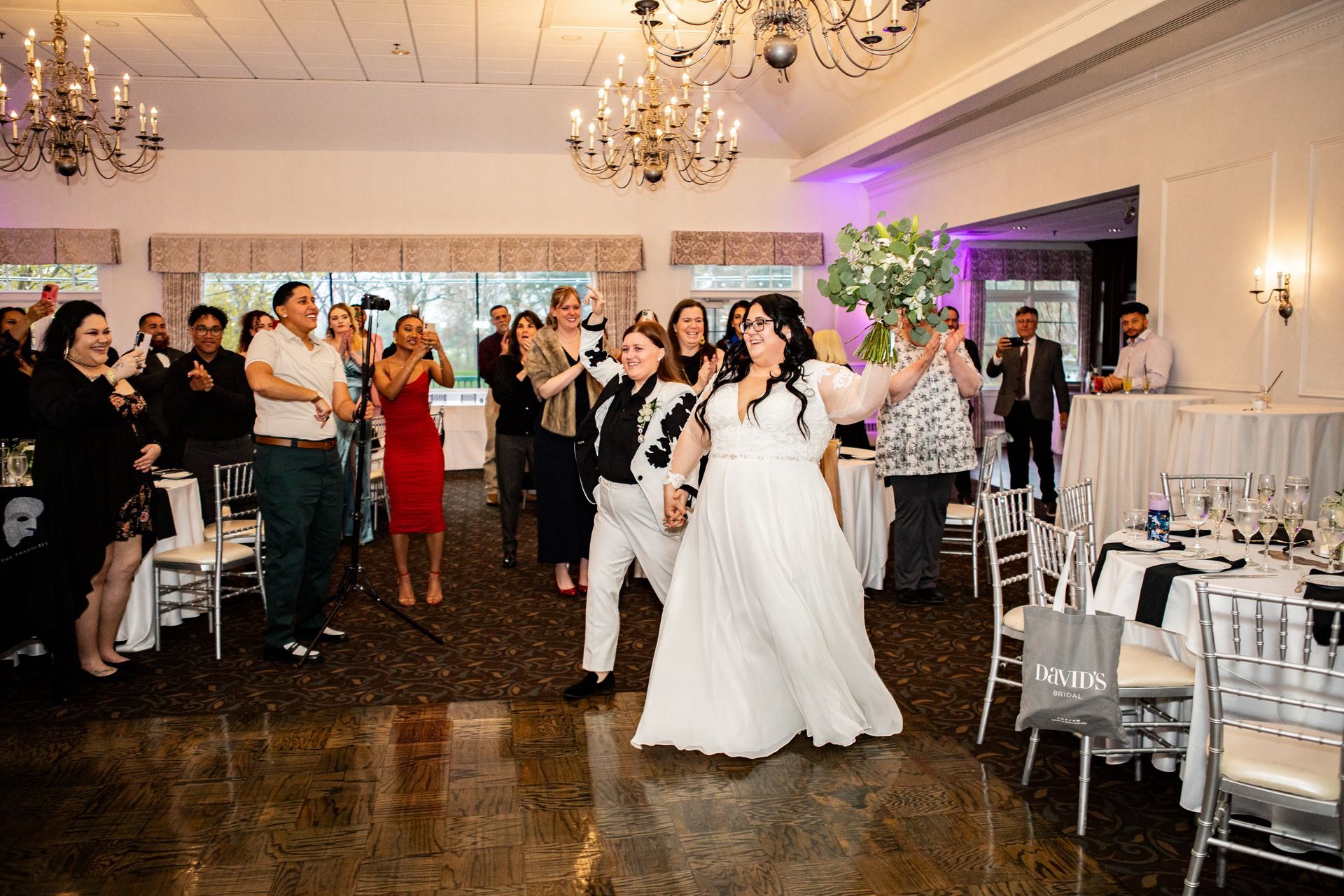 Lesbian couple entering their wedding at Black Swan Country Club