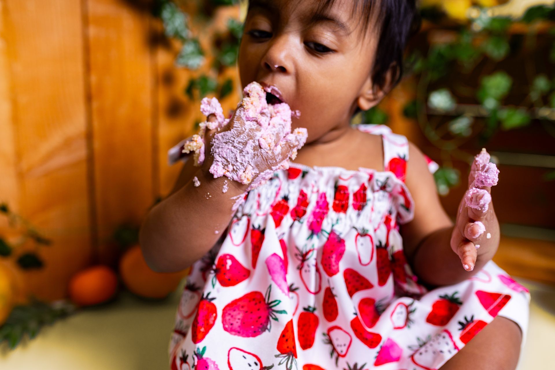 Baby posing on yellow background for citrus and jungle themed cake smash session