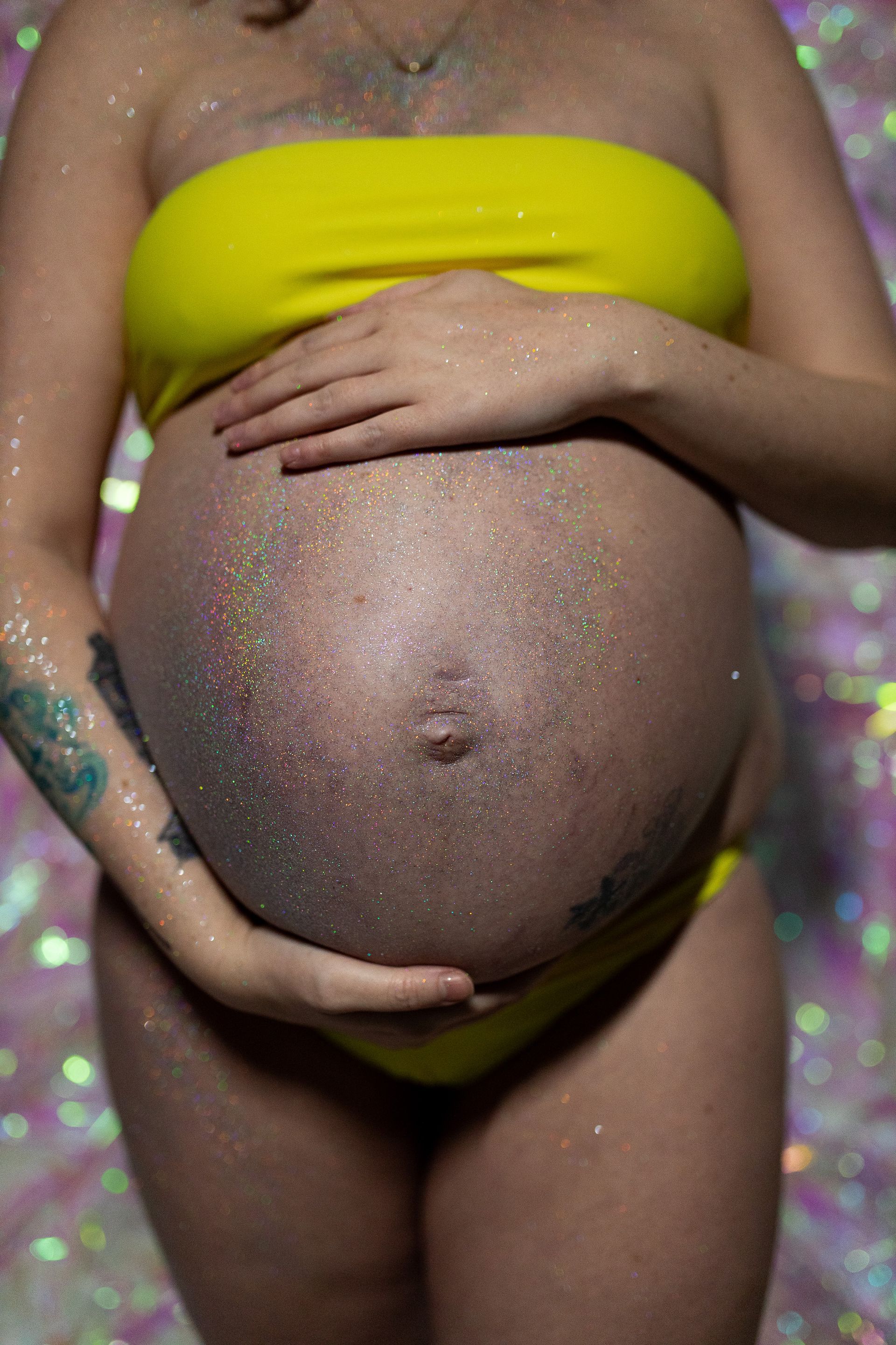 Maternity photography mom posing in milk on white background and close up of belly