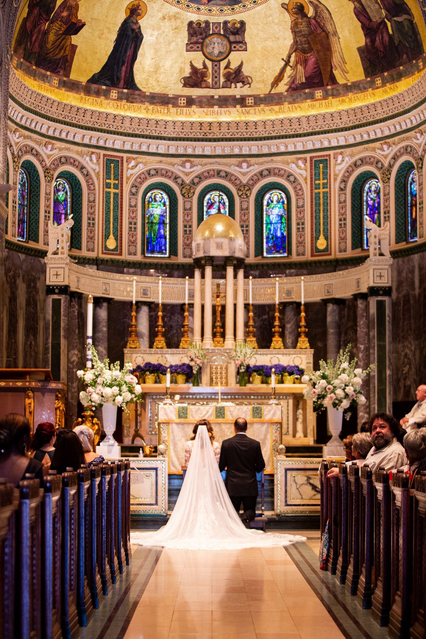 Boston church wedding with couple kneeling during mass