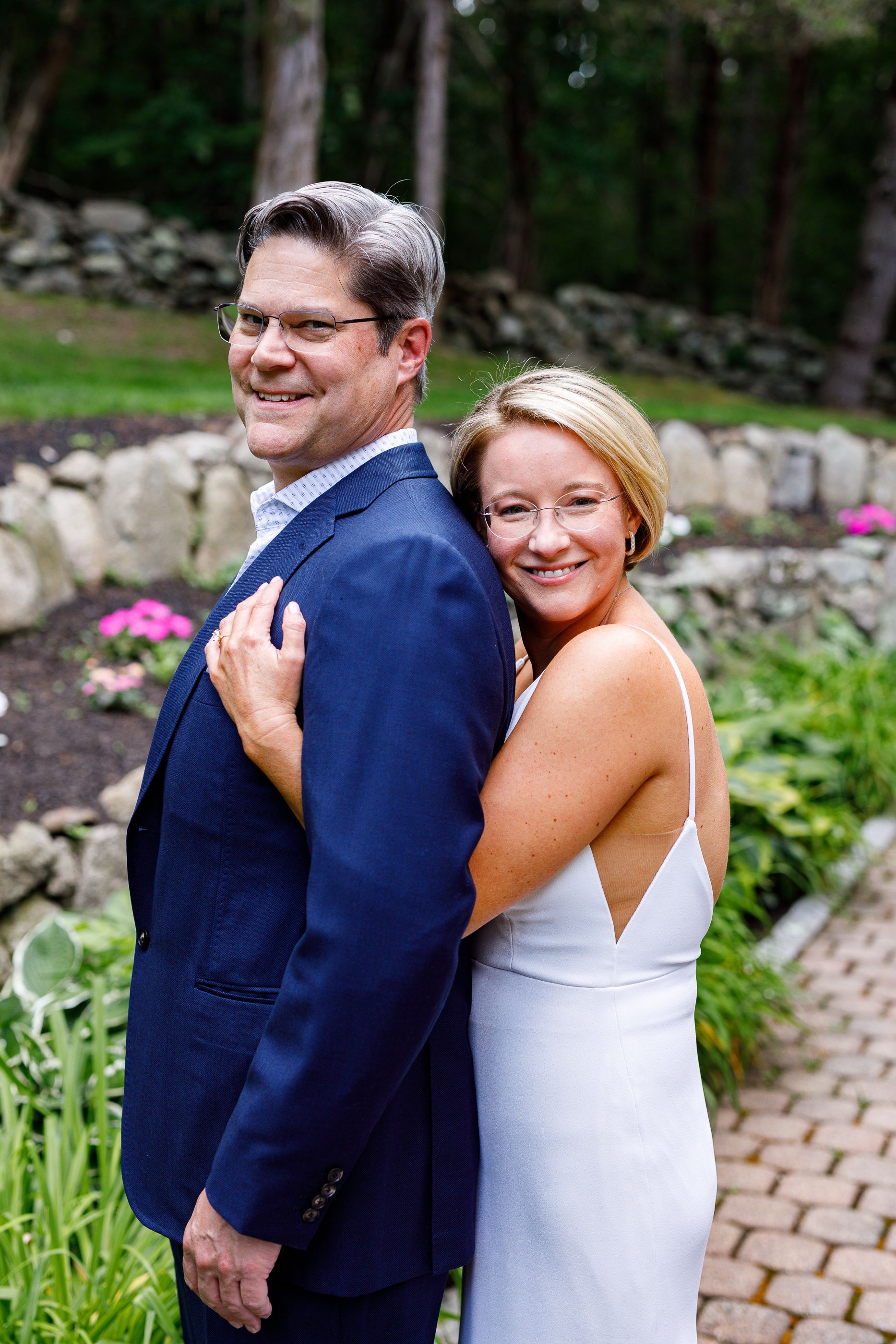 Bride hugging groom from behind