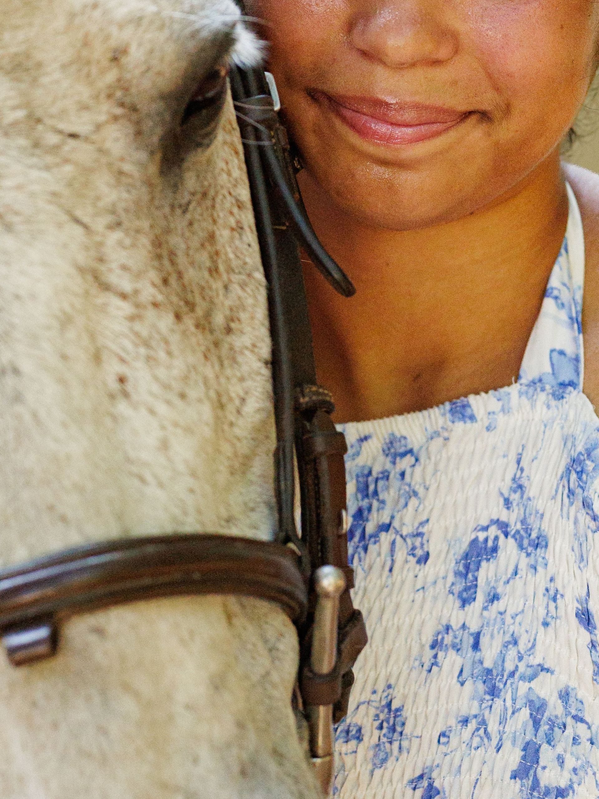 equestrian photography - young girl winning a horse competition in a blue shirt on her brown horse