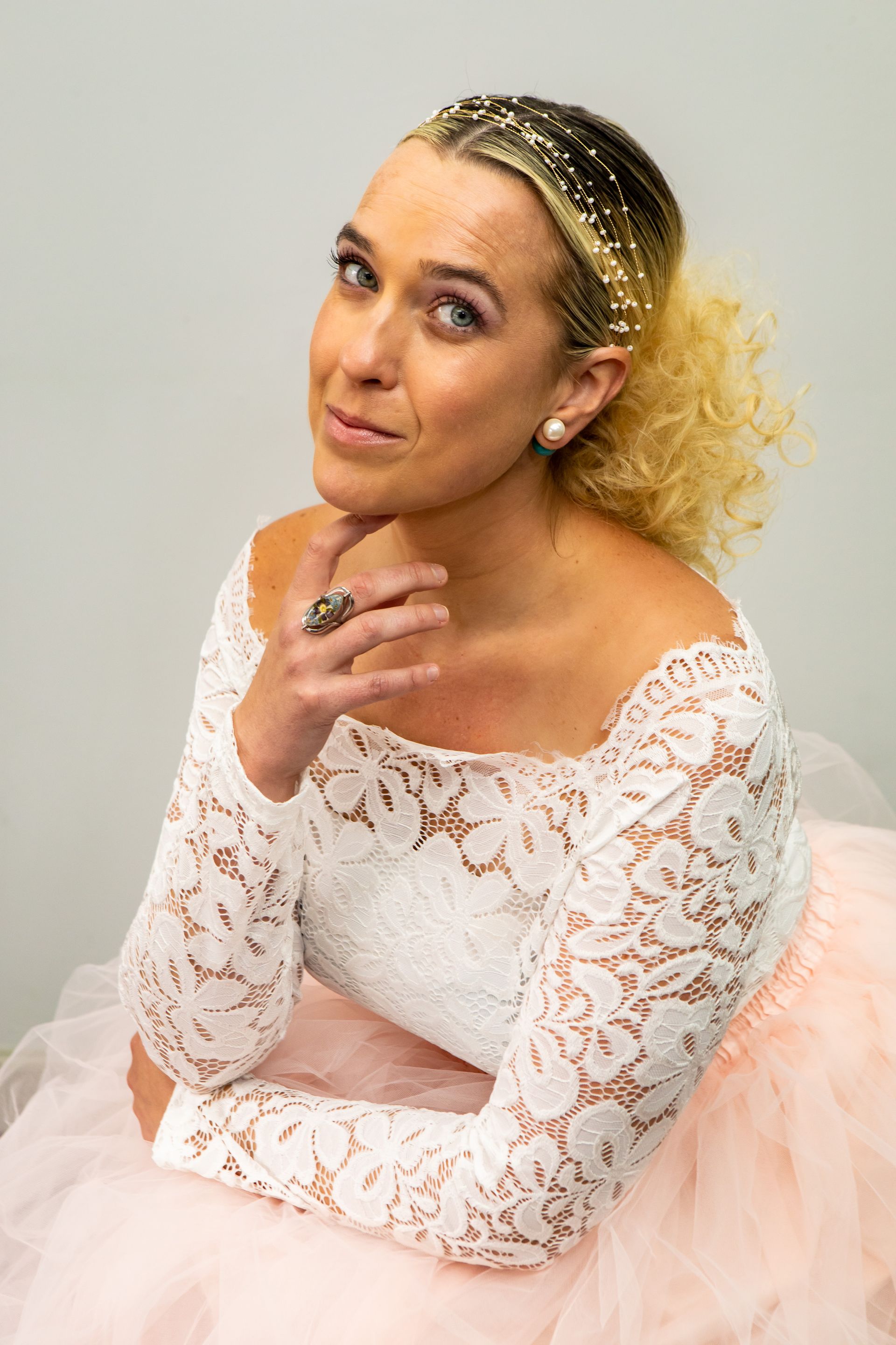 Photography MA - branding photograph  blonde women with hair styled up and curls in white lace dress