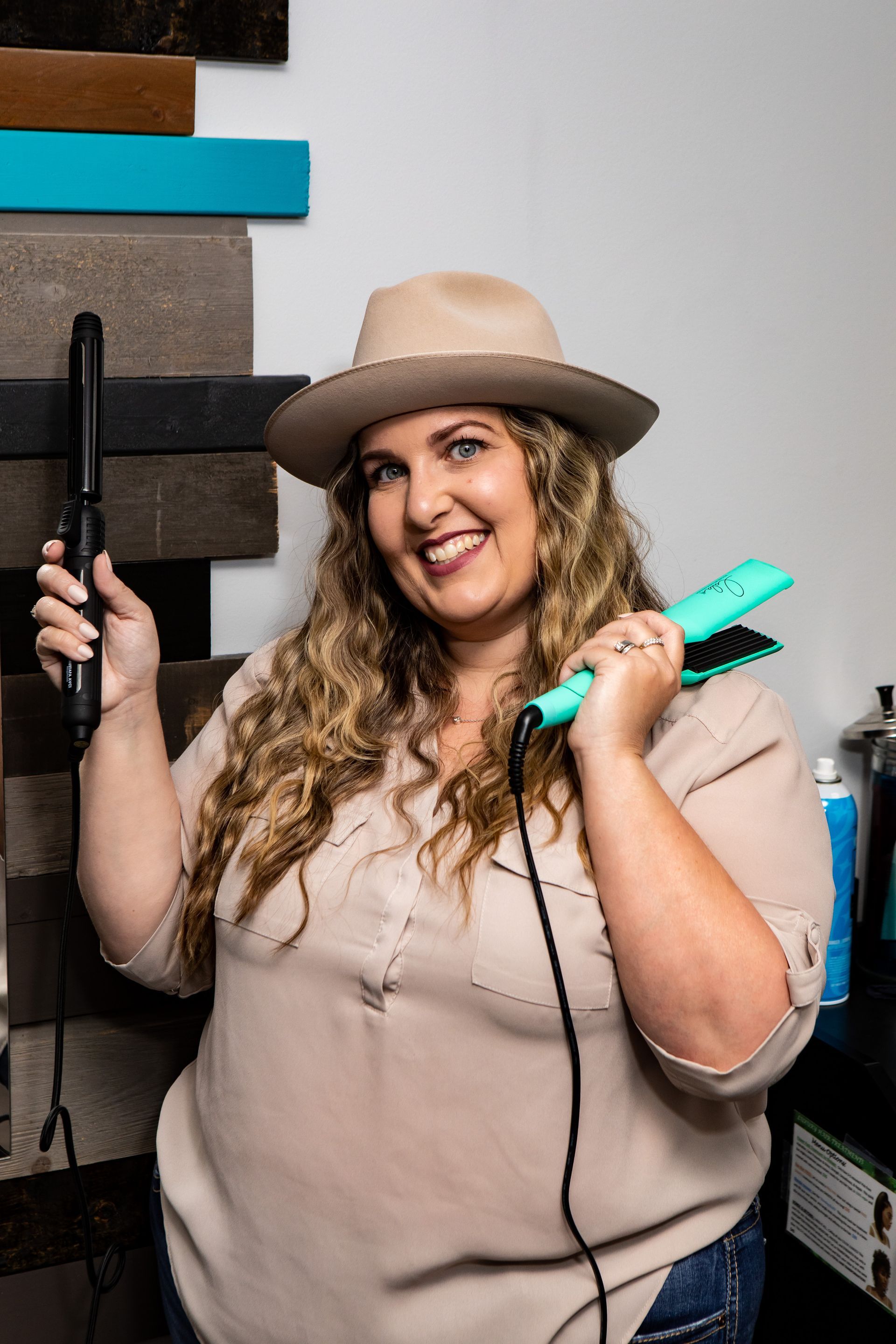 Photography MA - branding photograph with hairdresser holding curling iron and straightener 
