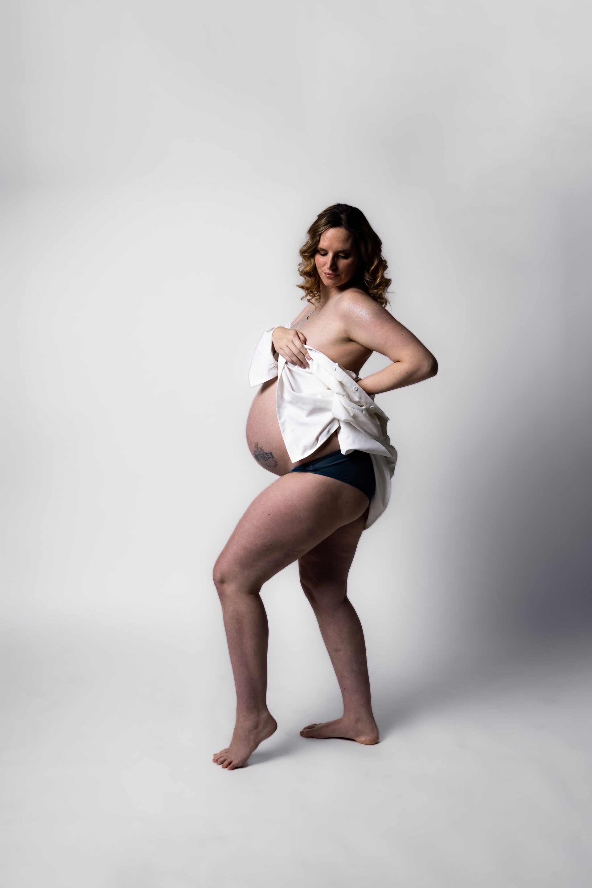 Maternity photography mom posing in milk on white background
