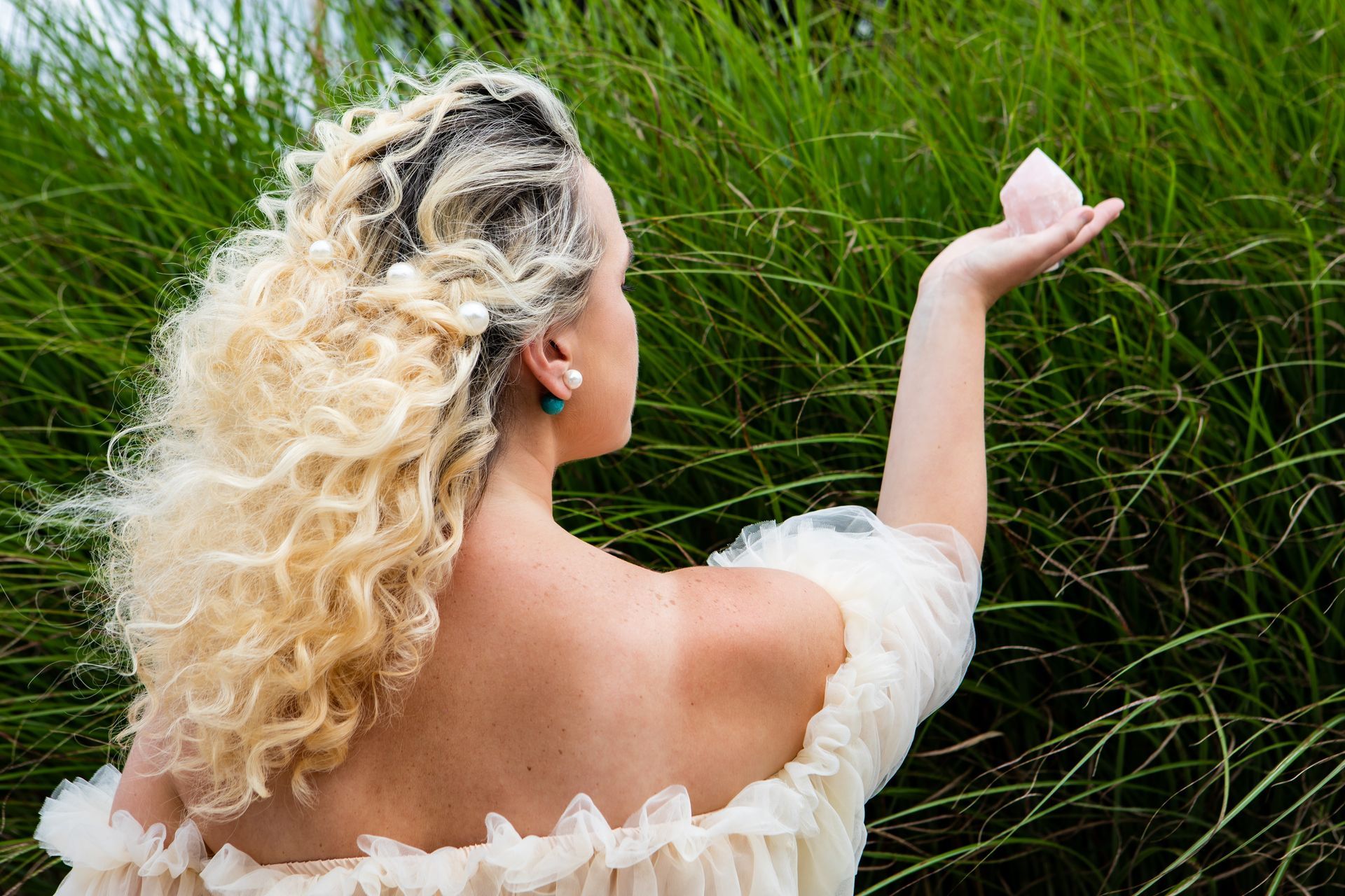 Photography MA - branding photograph   blond girl holding crystal in field